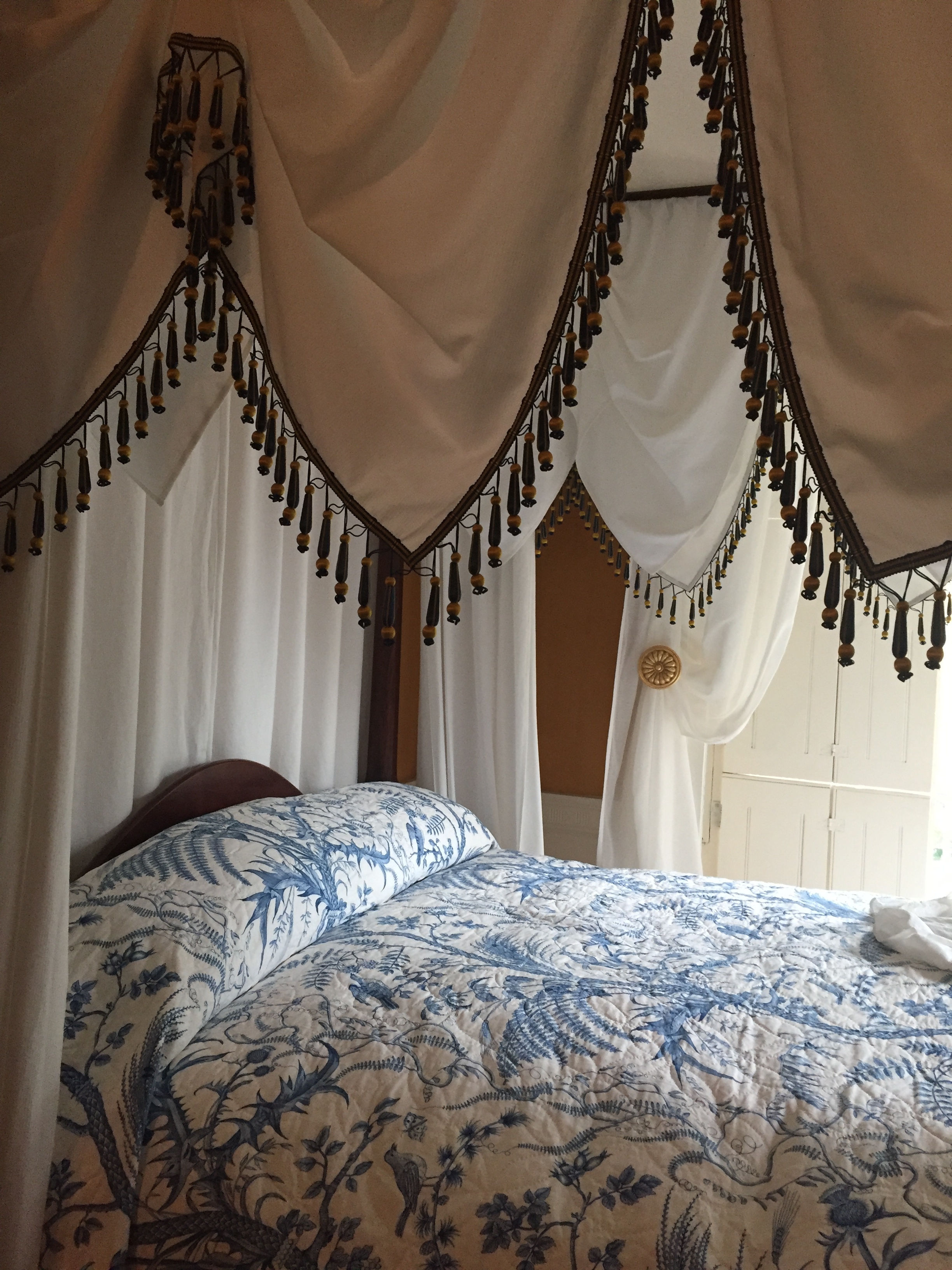 Georgian style four poster bed with upholstery hangings for ornate and warmth purposes.