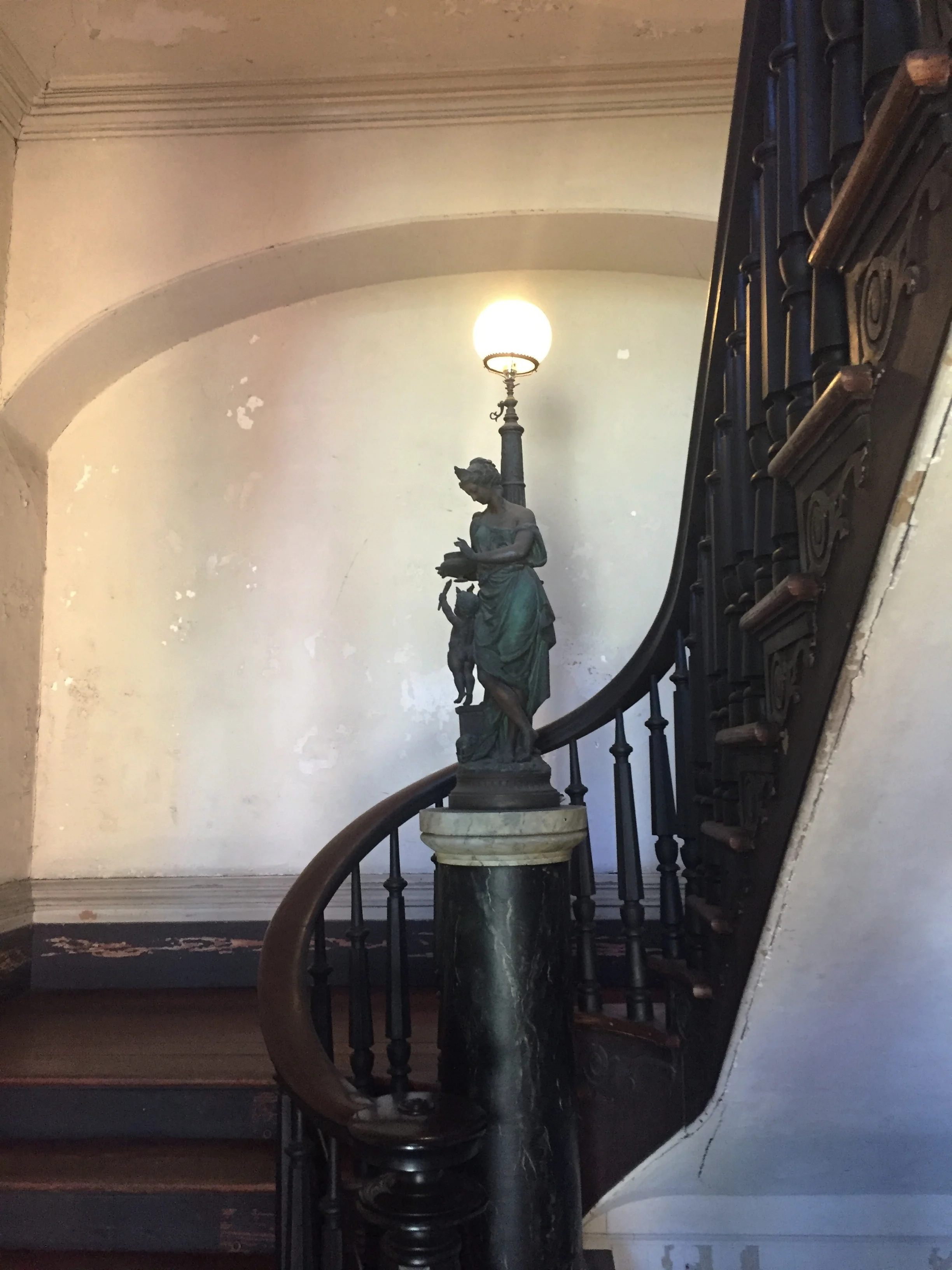 Main central stair hall leading to all three floors. This room is rectangular with a wooden staircase and two octagonal-and-turned balusters to each tread.