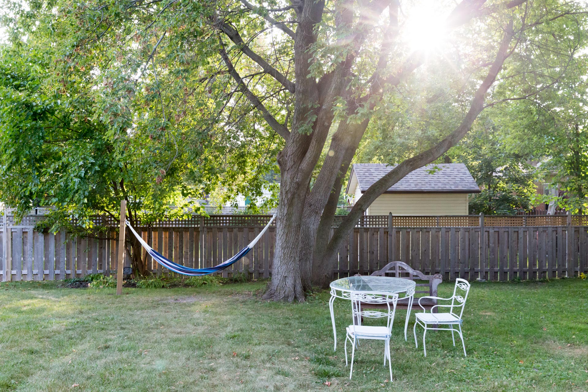 hammock hanging beside a patio set in The Ferg backyard