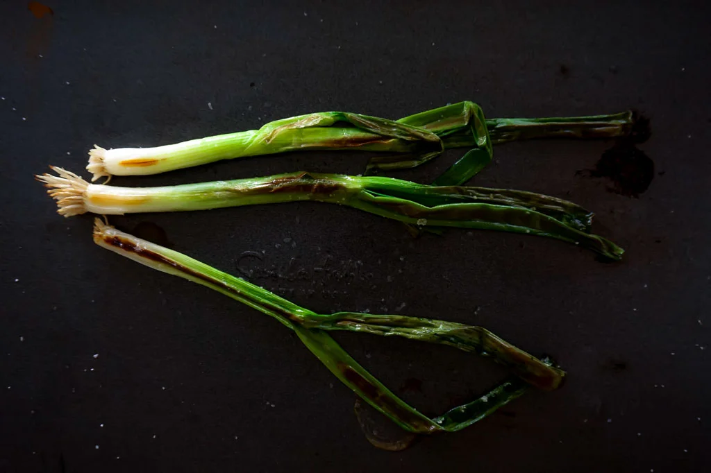 Charred scallions with romesco