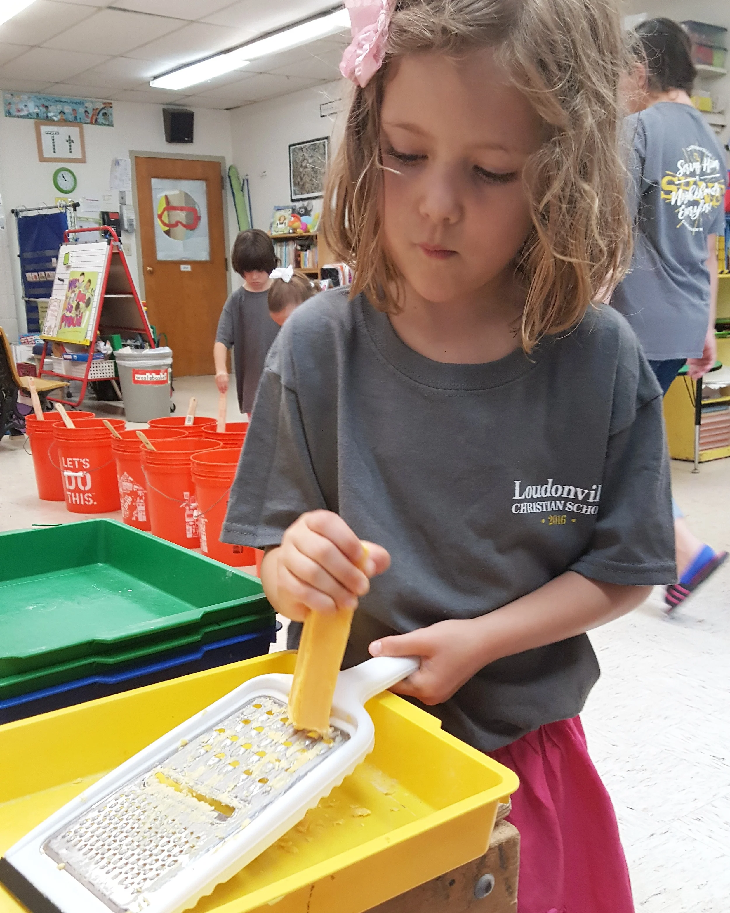 Elise working at the school Servathon making laundry soap to donate to the refugee families her class adopted.