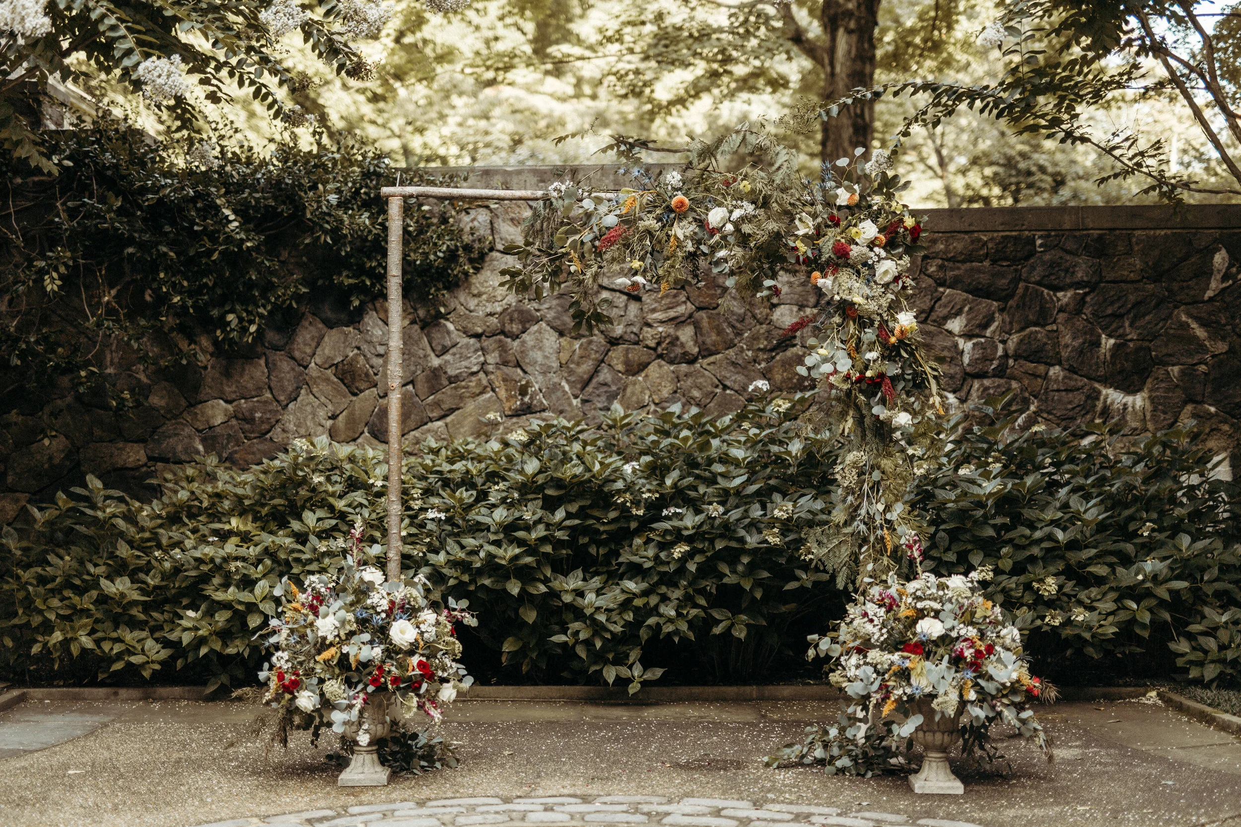 Megan & Craige’s Warm AUgust wedding at Winterthur estate It’s August and it’s hot, but there is something that makes the lower reflecting pool at winterthur estate in delaware cool and comfortable in the peak of summer. Perhaps it’s the shade from the ancient trees and bushes, maybe its all the stone from the walls and patio. Either way, the space was the perfect backdrop for our boho inspired arbor and ceremony urns. Megan’s color palette helped us create a ceremony that was full of fresh color and texture. WE LOVEd the way this turned out!!! thank you victoria selman photography for the lovely images. www.victoriaselman.com