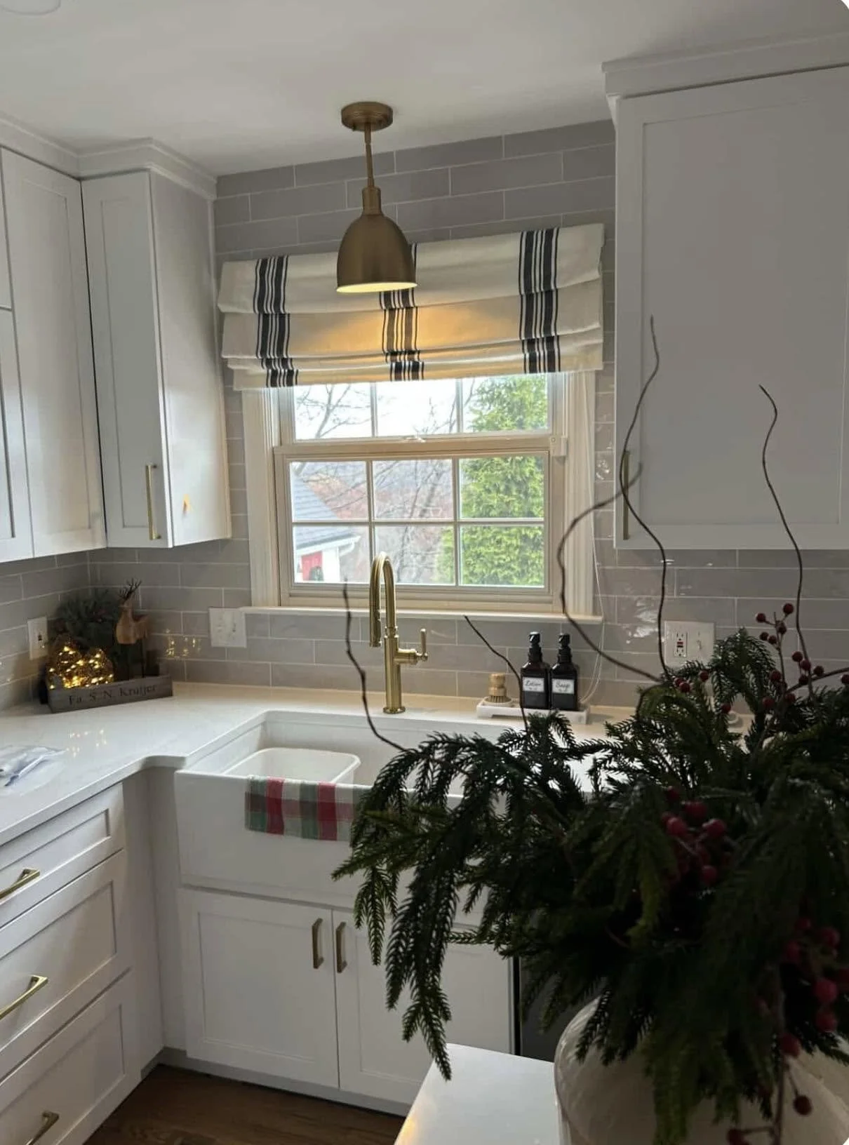 Outside mounted corded roman shade in a kitchen window