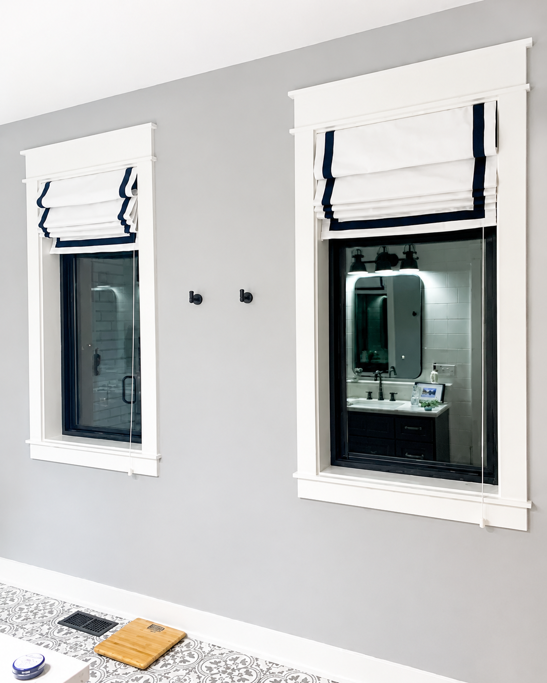 black and white roman shades in a living room window