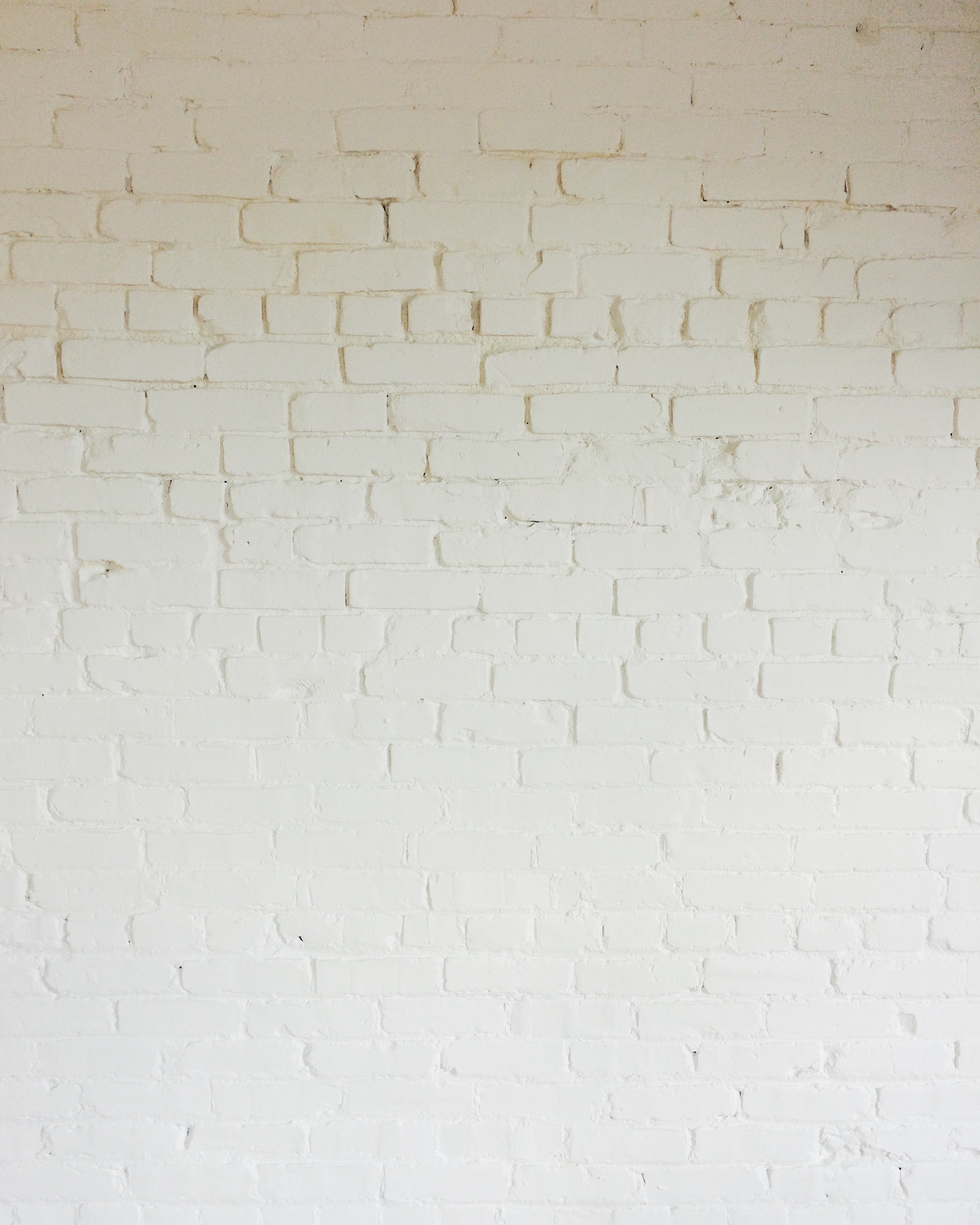 A simple palette of whitewashed brick defines the space.