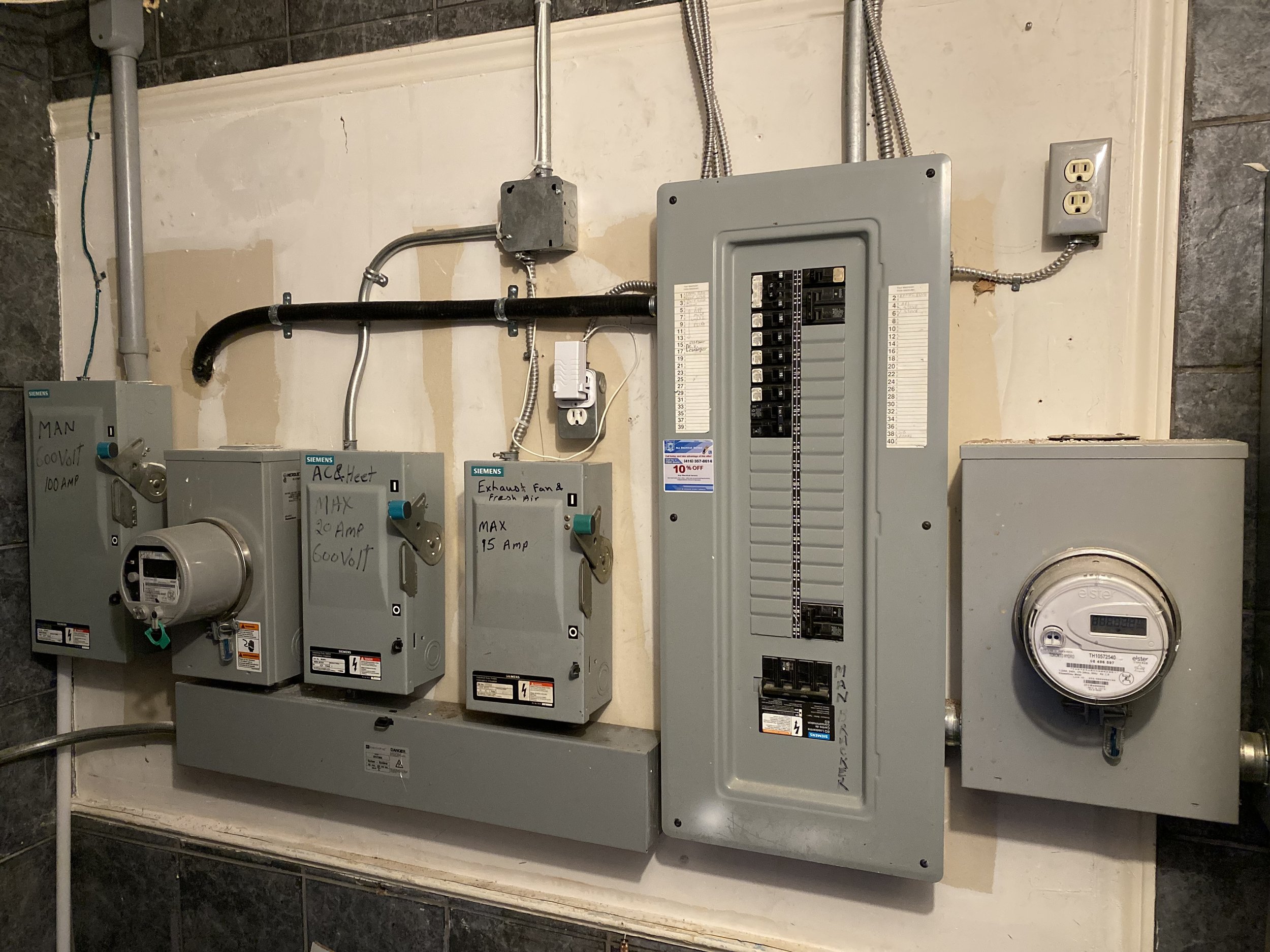 A tested and connected electrical panel and meter with switches and grounding