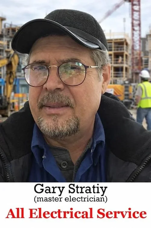 Portrait of master electrician Gary Stratiy representing All Electrical Service at a construction site background.