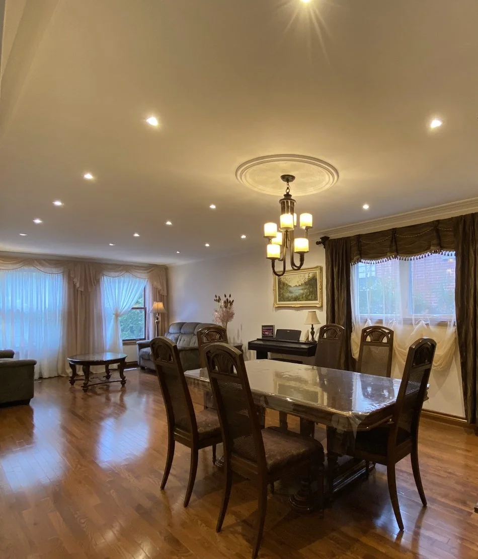 Installing recessed ceiling lights in the dining room and designer chandelier for home decoration