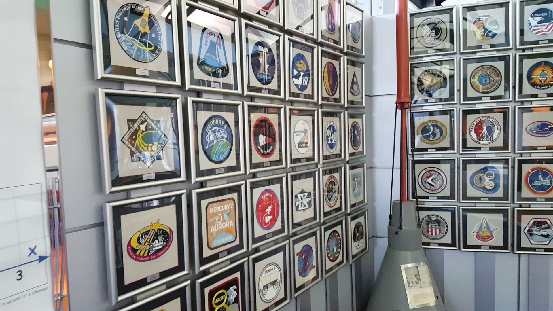 The wall of patches stretches on and on with a patch from every space mission, framed and hung in a row