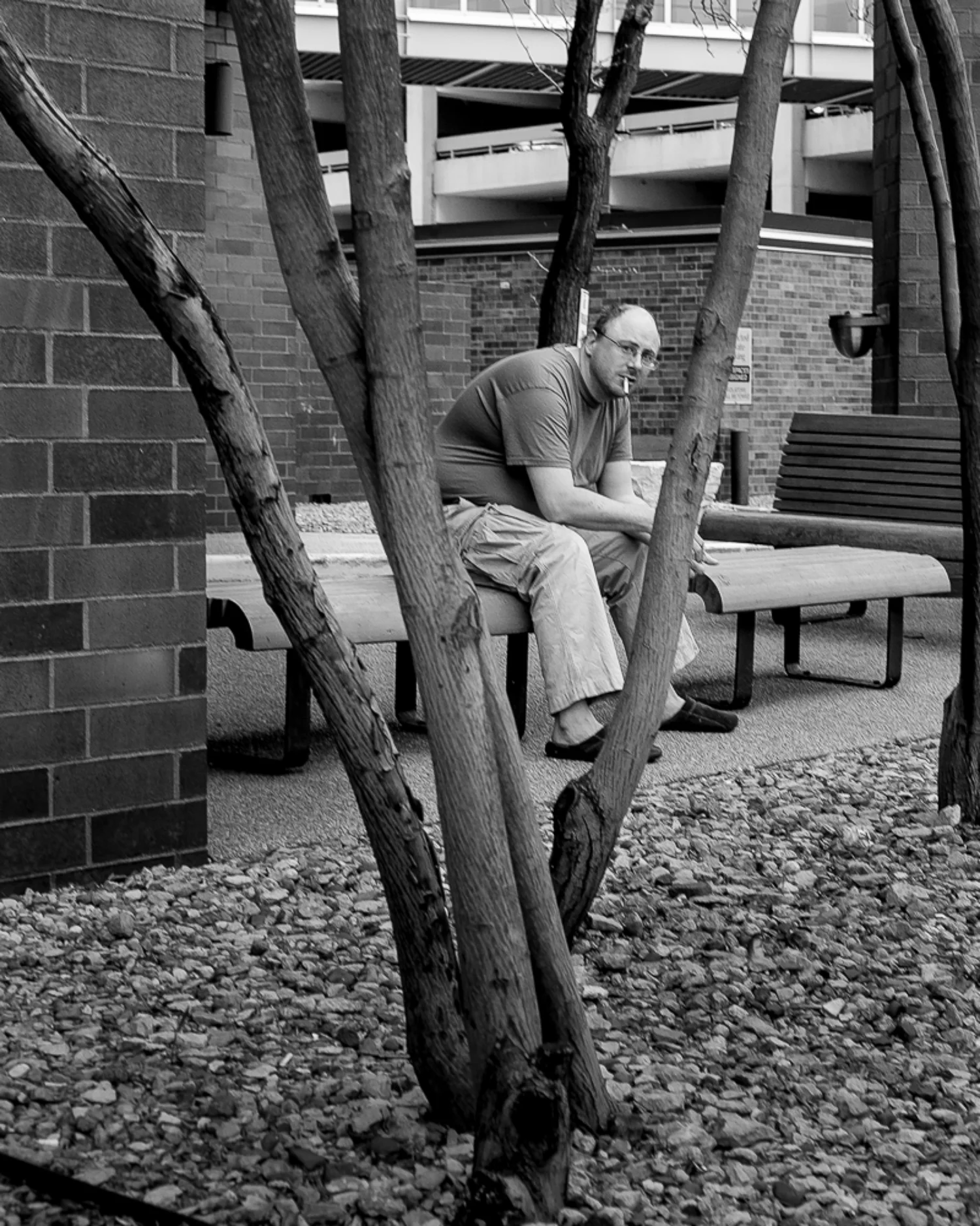 Guy smokeing on bench B&W1.jpg