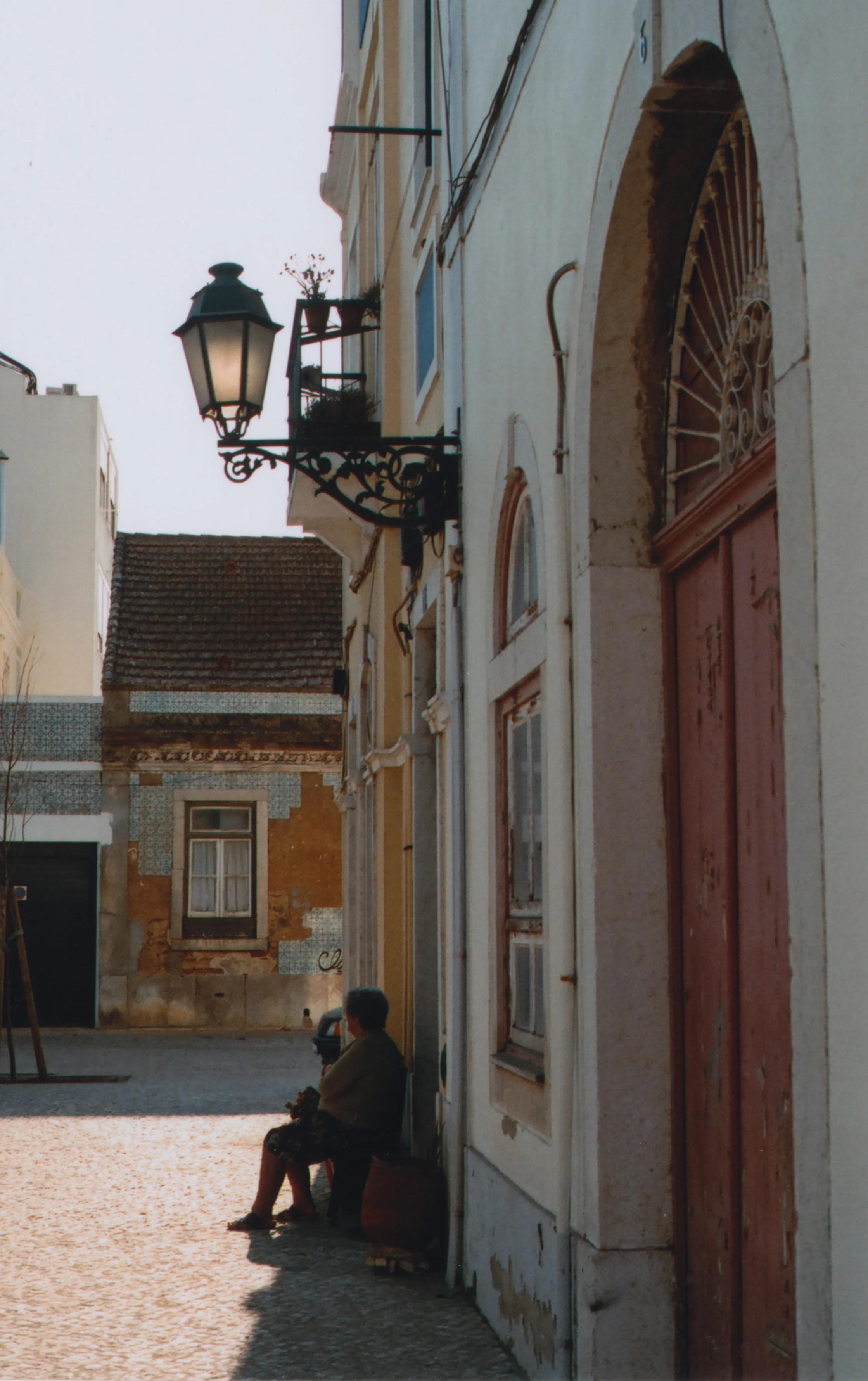 Old lady, probably bored, in Seixal.