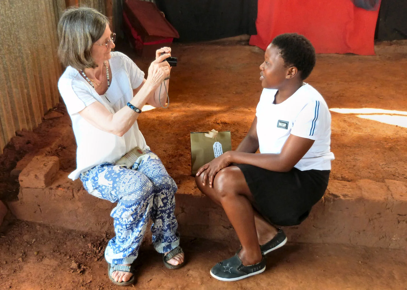 Sue taking a video message from a sponsored student
