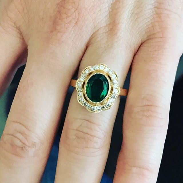 Bezel set rich green natural emerald with an antique diamond halo  #maybirthstone #diamondconsultants