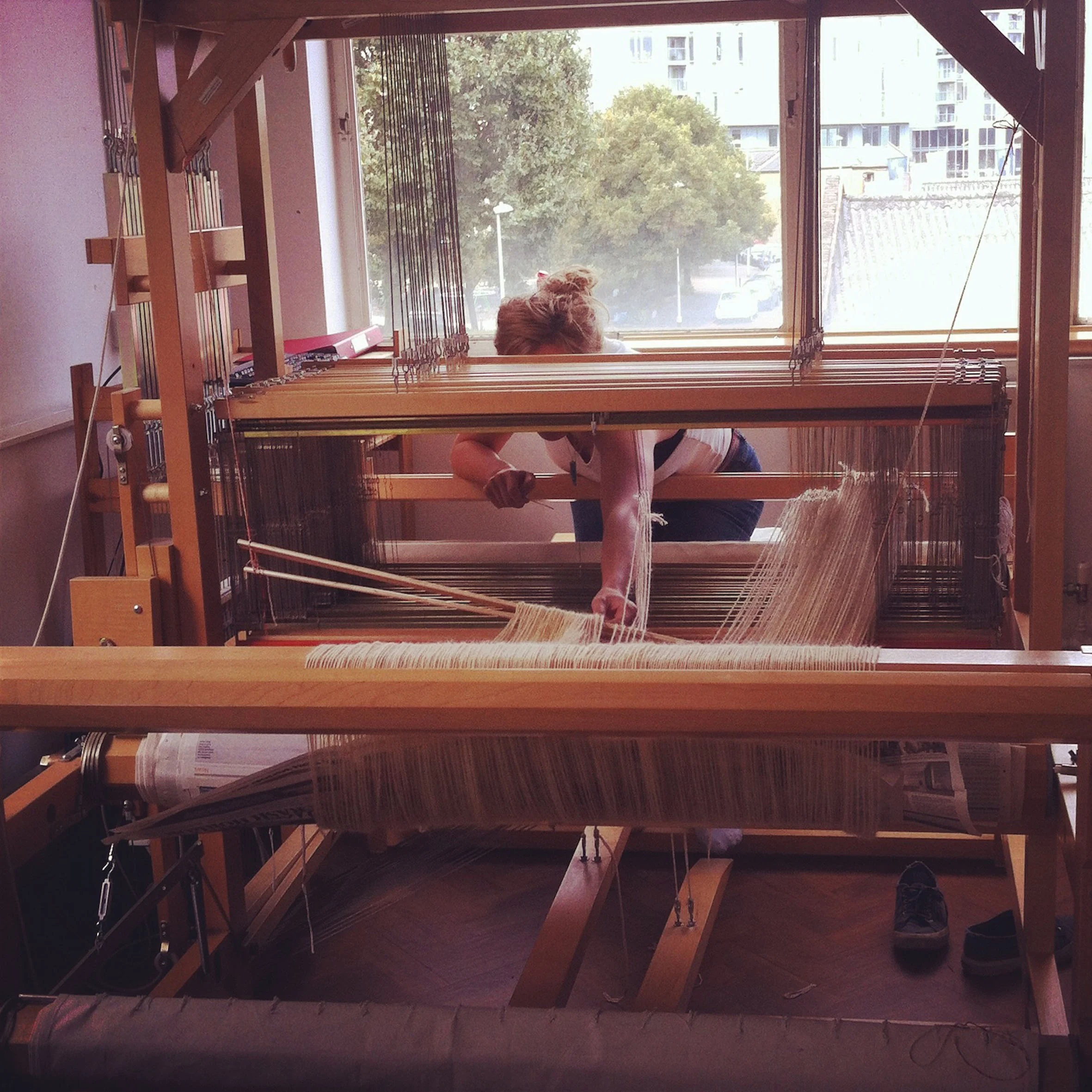 Beatrice in her studio, working with the structure of weaves, generating design and composition.