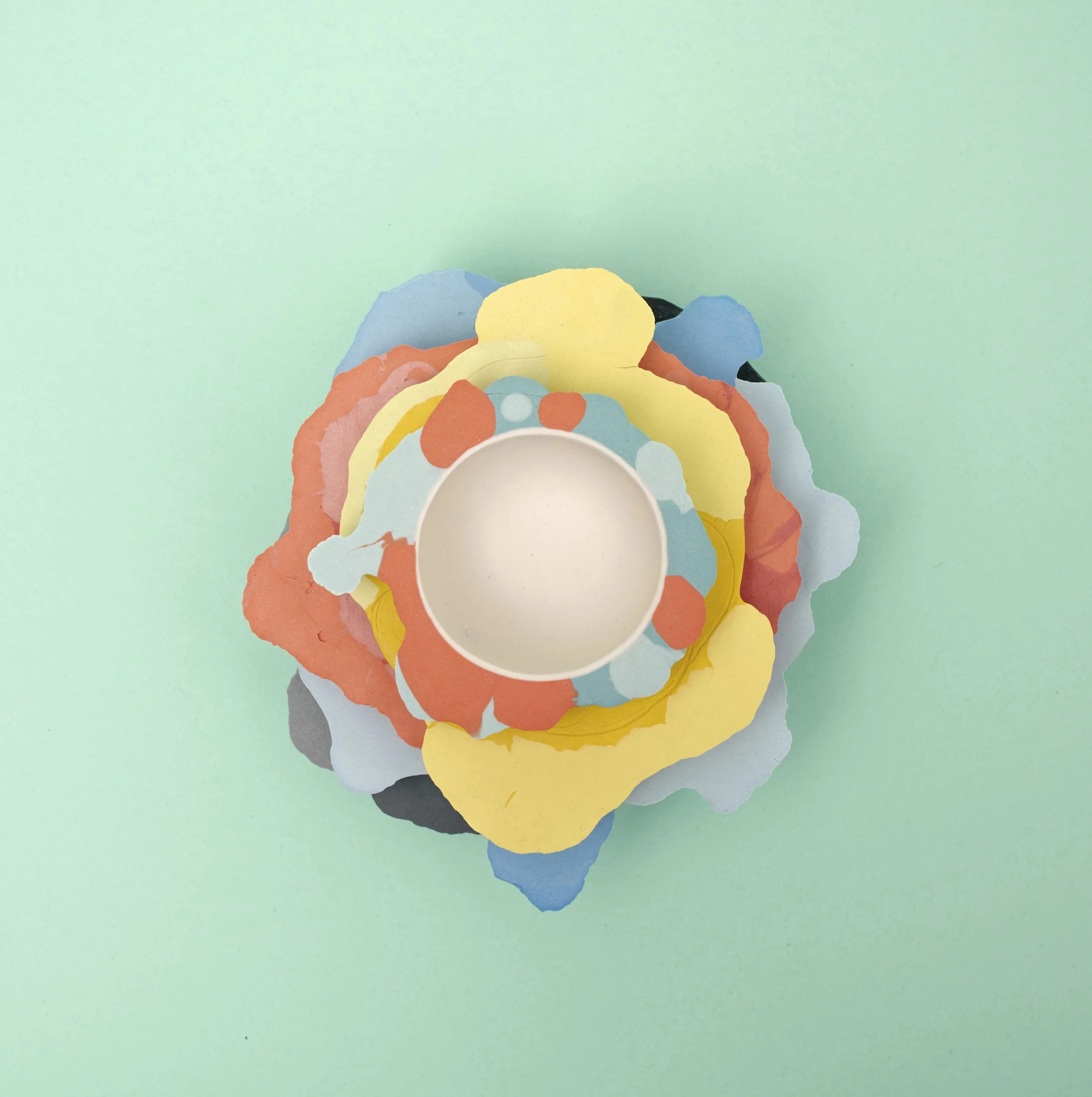 The objects of the 'Liquid Series' stack up to form a graphic composition