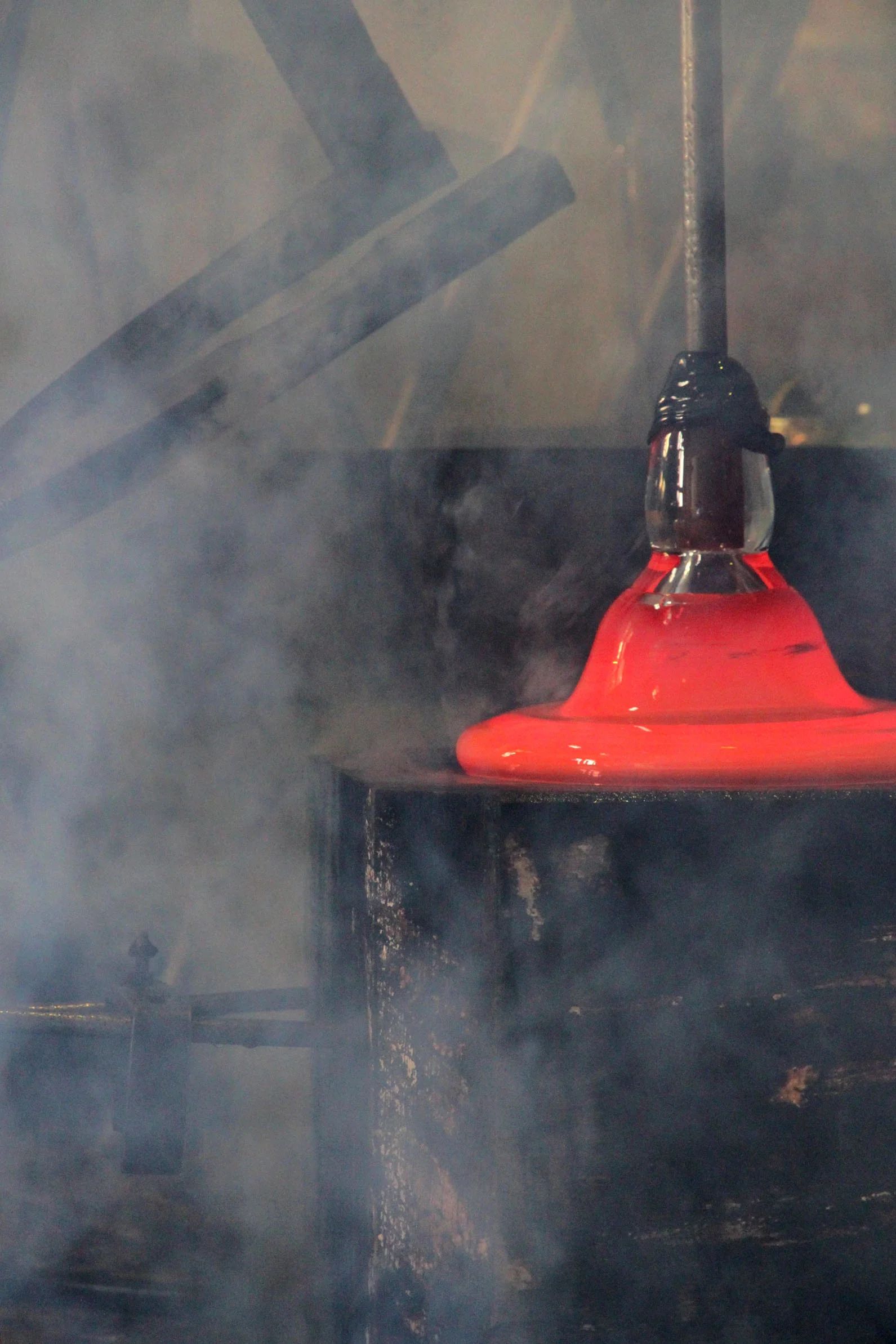 Glass is blown into a wood mold for the Stacking Vessels