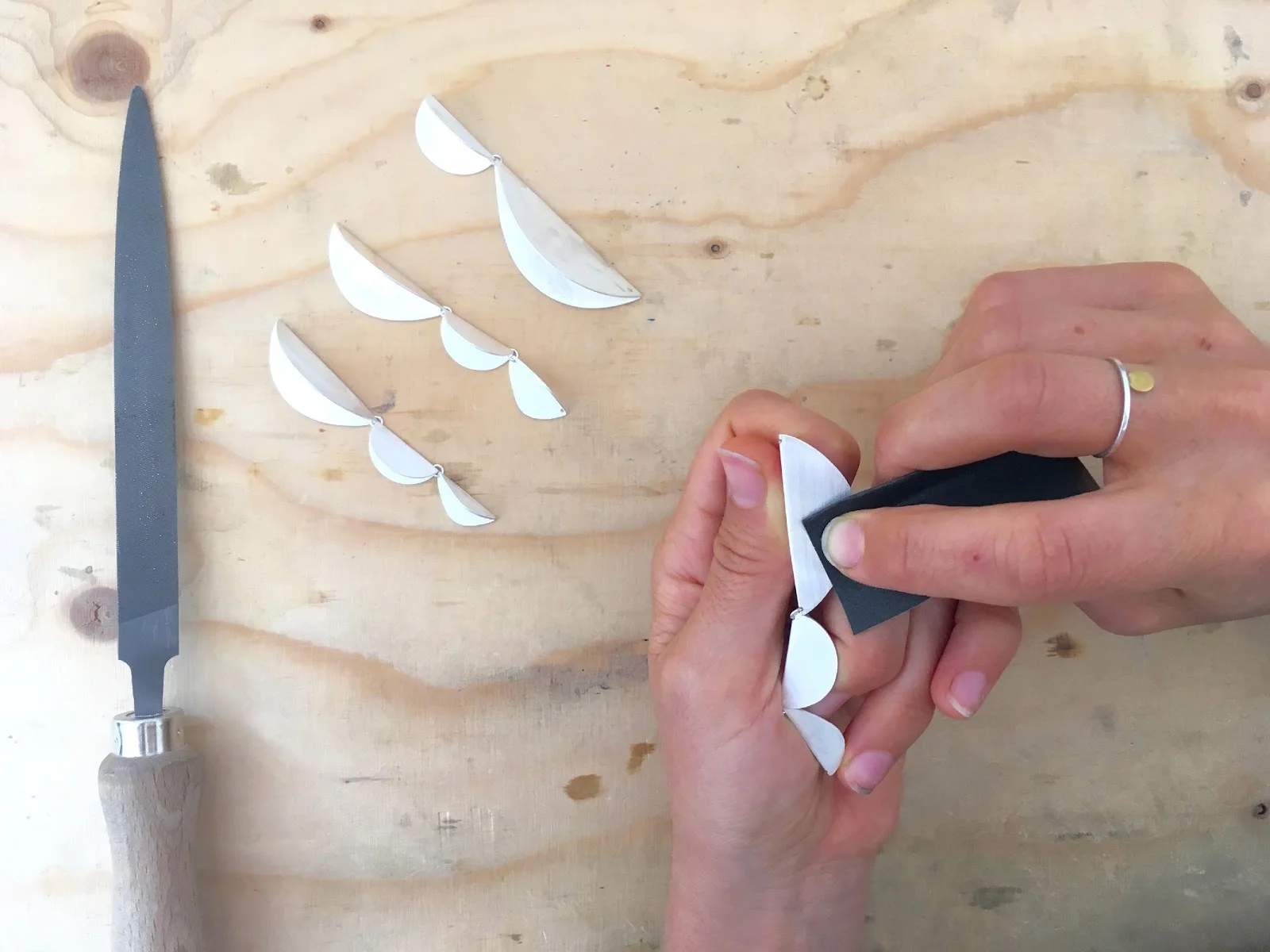 Sterling silver shapes being sanded for the SUCCULENTS collection by Megan Collins Jewellery
