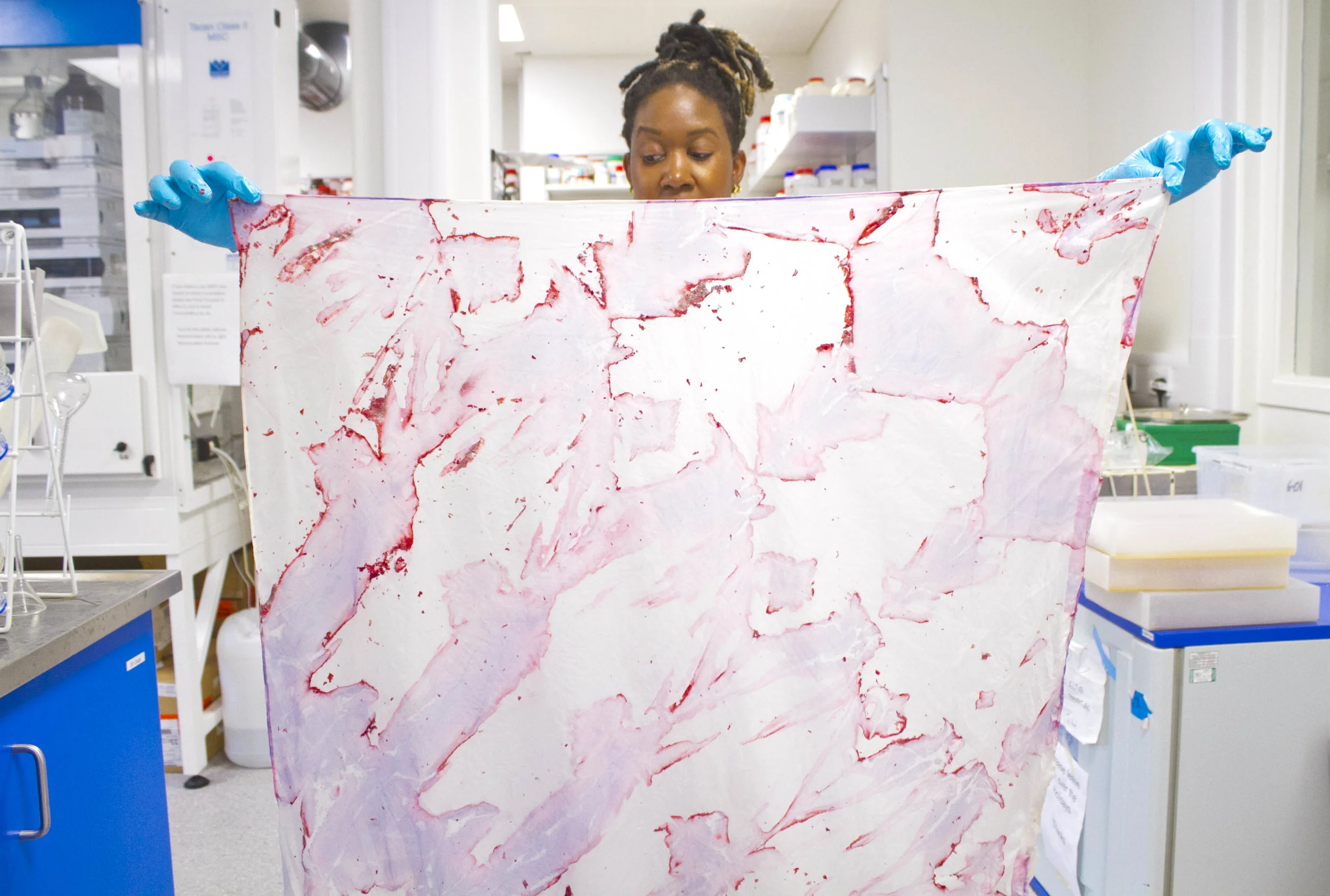 Natsai Audrey Chieza with one of the fabrics dyed by her using the interaction with pigment-producing bacteria.
