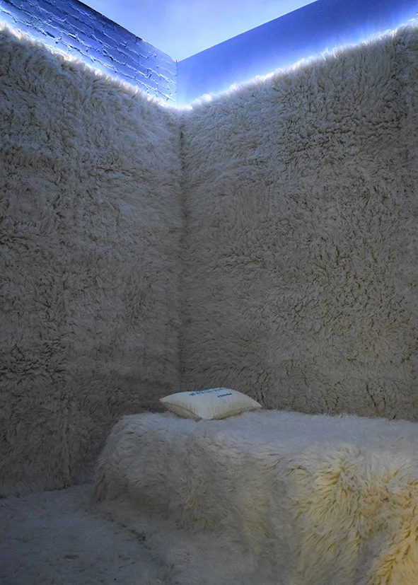 Flokati wool rugs line the floor, walls and bed of the Room to Daydream