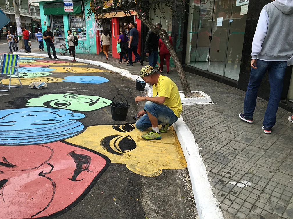Gypsum-based paint transforms the high-traffic intersection into a pedestrian-oriented plaza.
