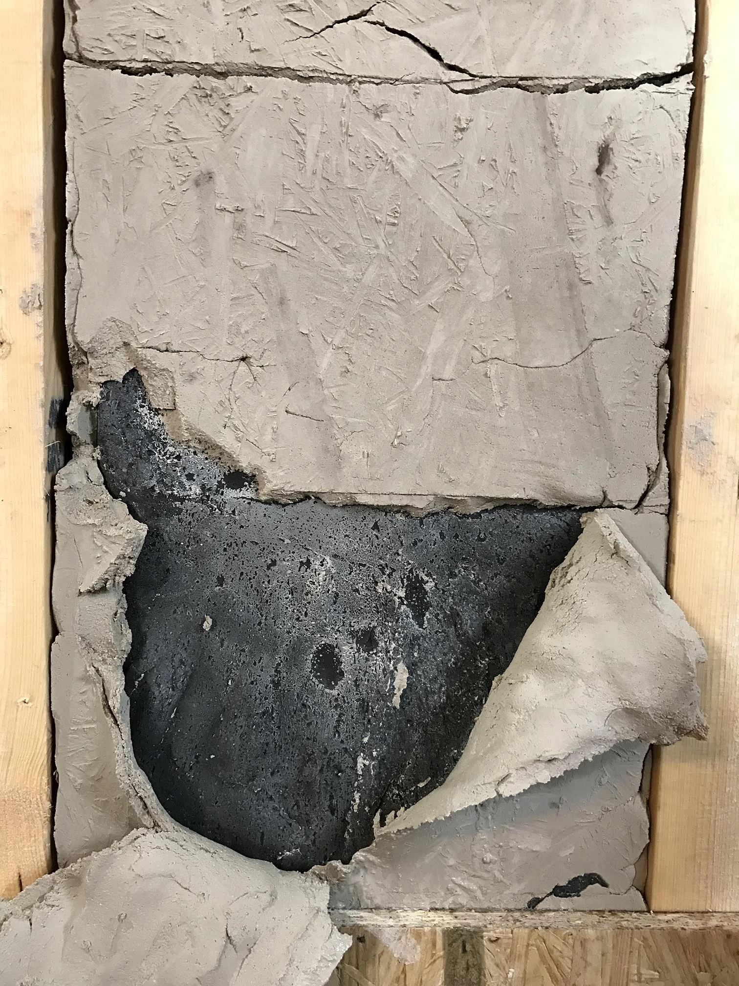 Casting a composite of Wax Paraffin and Carbon in a mould of clay, for the Three-Pillar Seat by Ida Elke, created for the Age of Man exhibition, Milan Design Week 2017