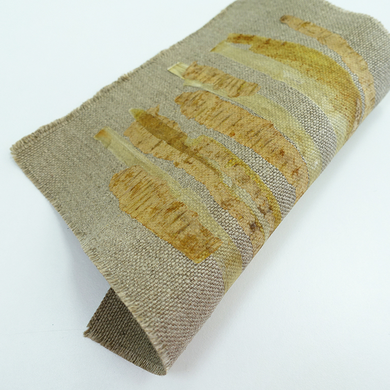 Combining vegetable peels and textile: Asparagus and Parsnip peels on unbleached canvas, by Angelique van der Valk