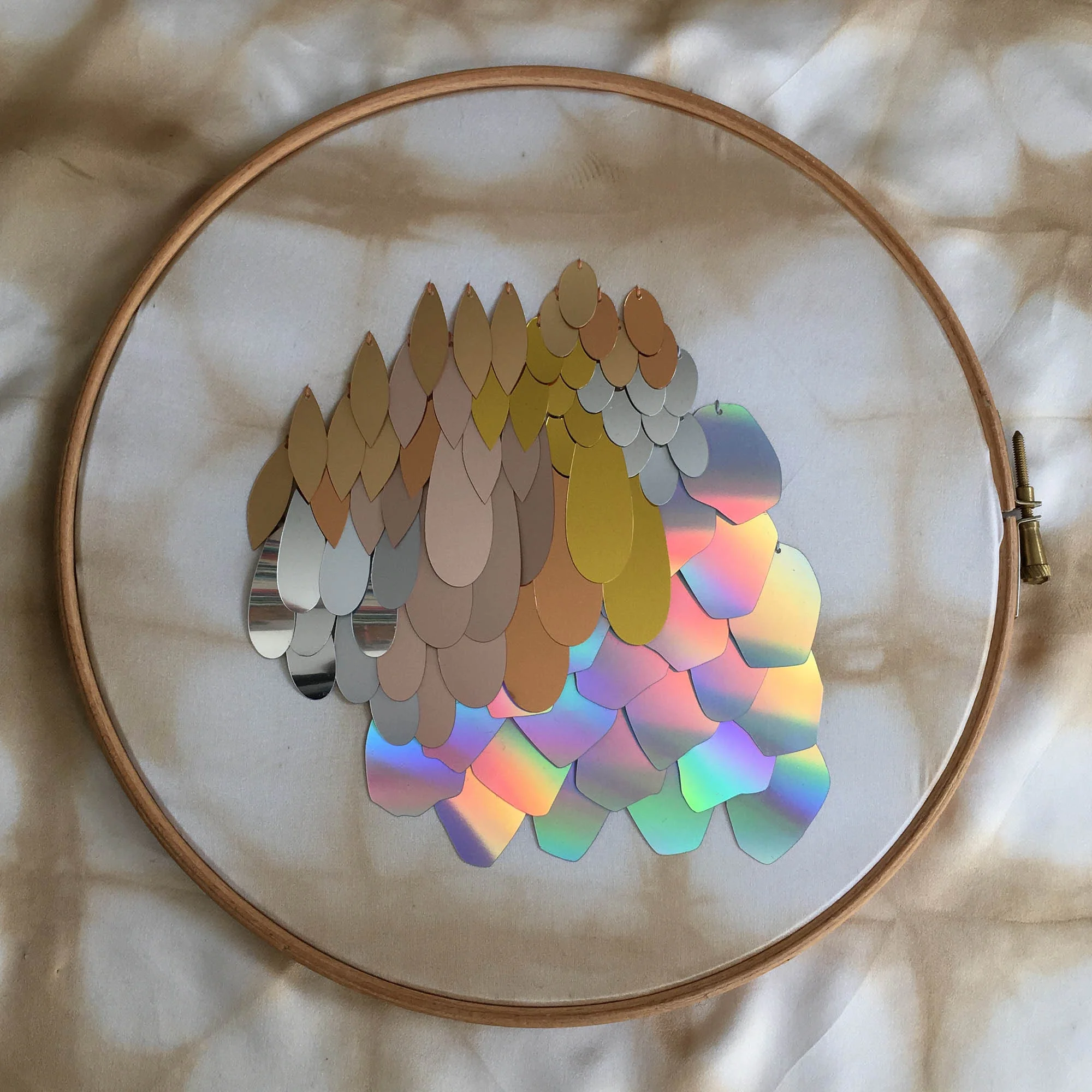 A hybrid assembly of sequins custom cut from Recycled PET plastic by The Sustainable Sequin Company.