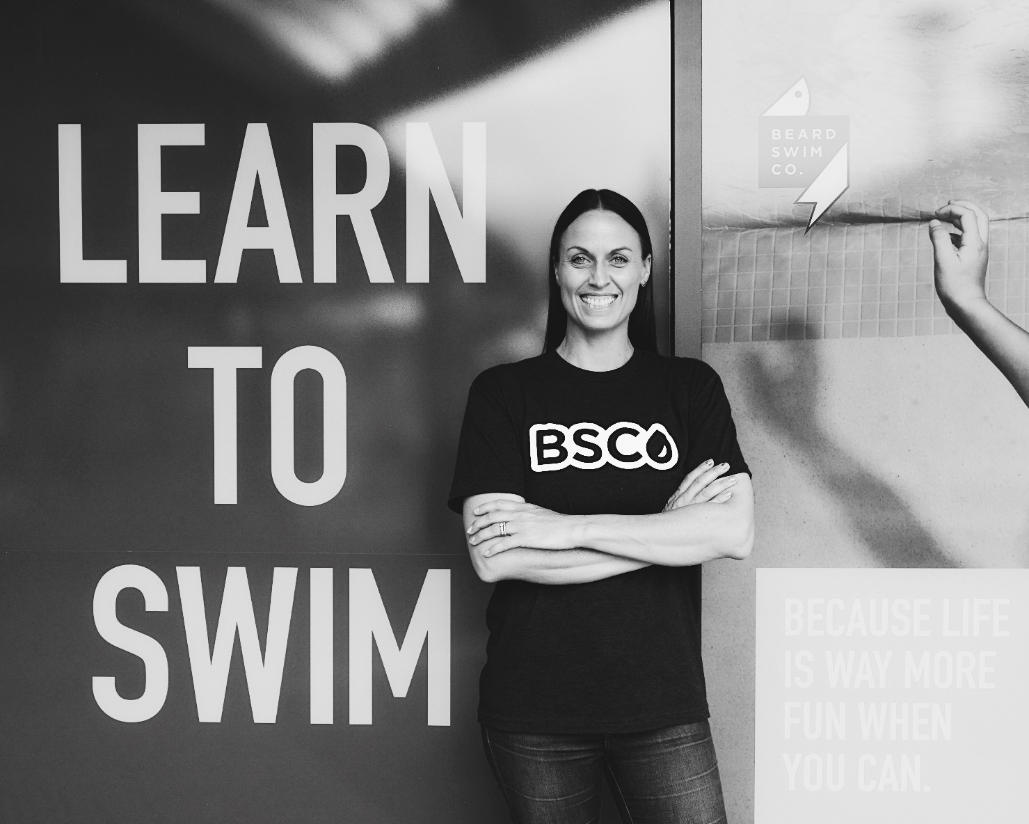 Amanda Beard, seven-time Olympic medalist and former world record–holding swimmer, smiling in front of Beard Swim Co.