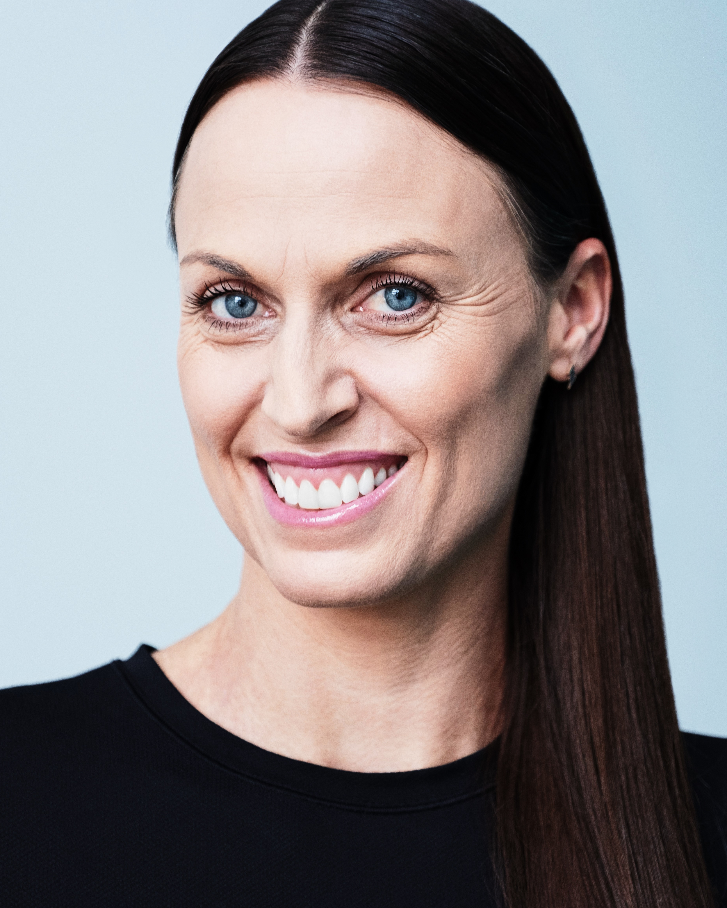 Amanda Beard, seven-time Olympic medalist and former world record–holding swimmer, smiling in a professional portrait.