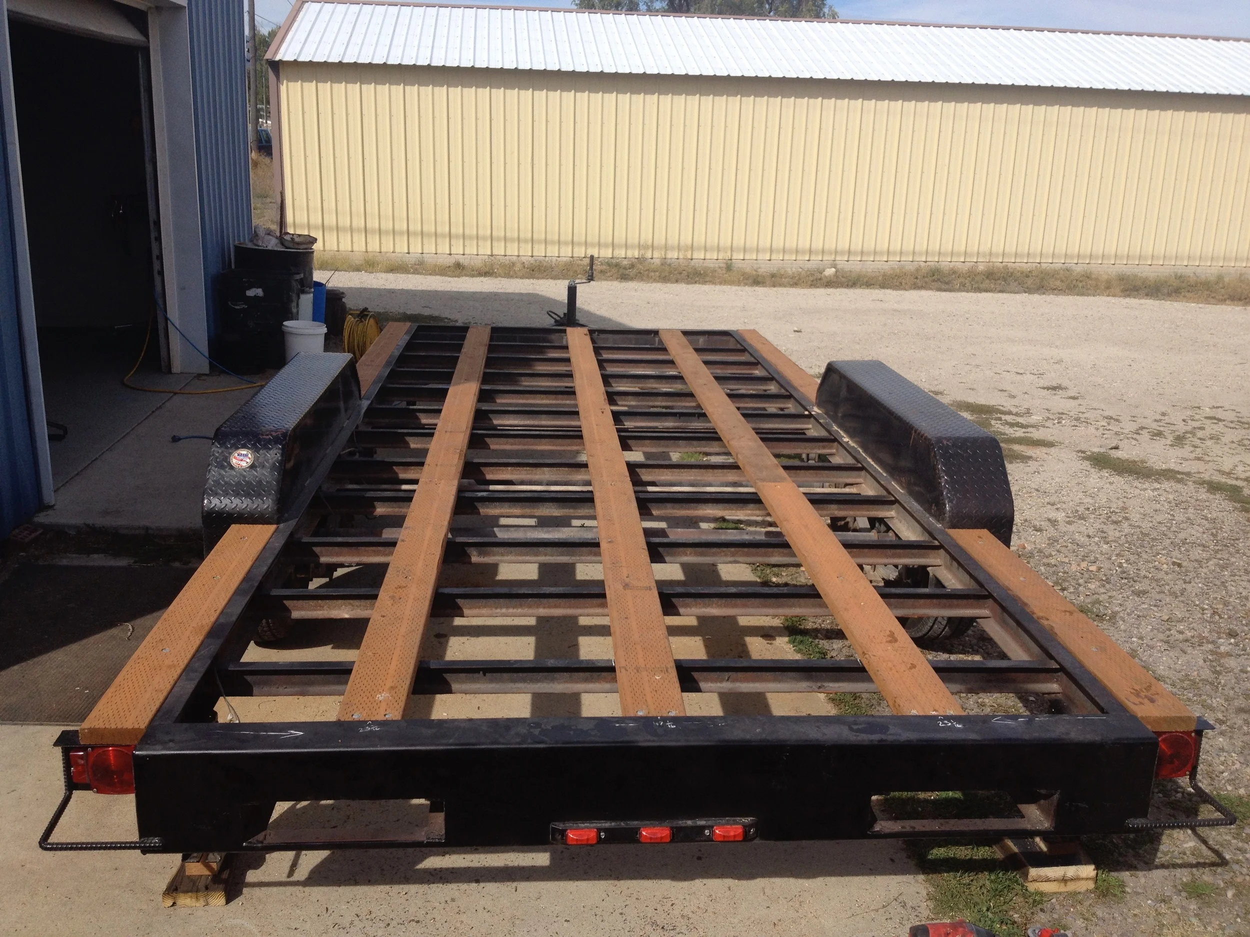 Stripped of its old deck, the trailer is given joists, flashing, insulation, and the subfloor.