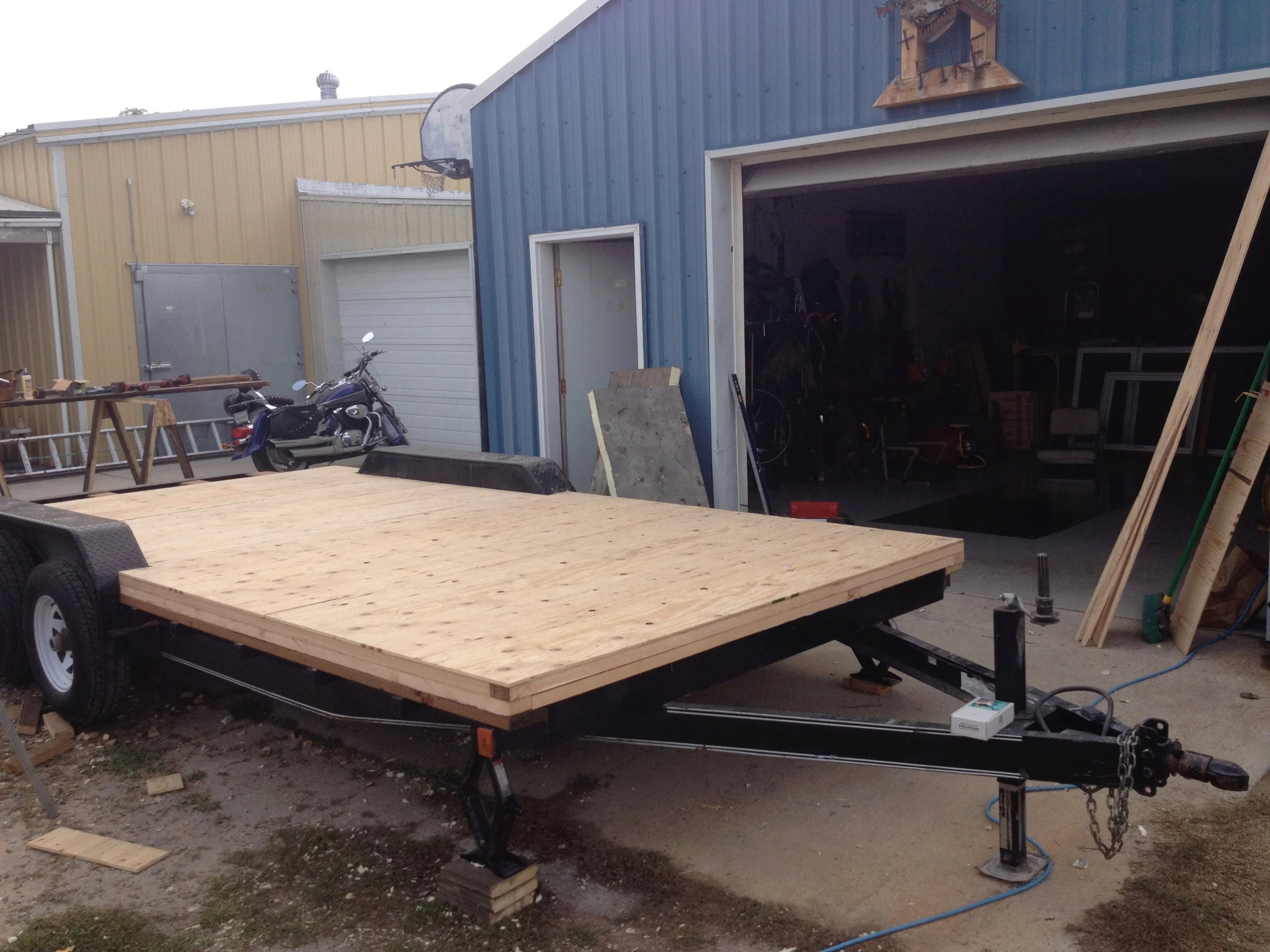 Stripped of its old deck, the trailer is given joists, flashing, insulation, and the subfloor.