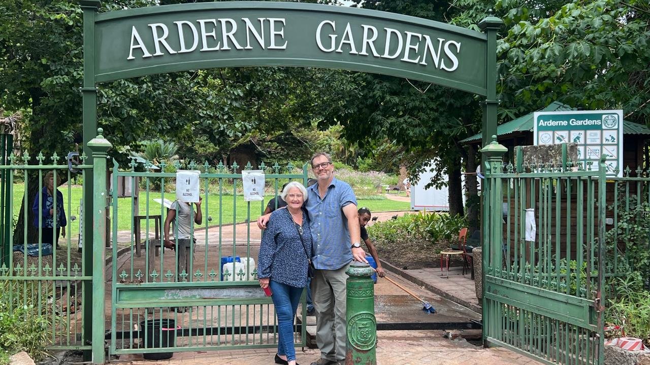 Rose Meny-Gibert and Paul Barker stand at Arderne Gardens arch.
