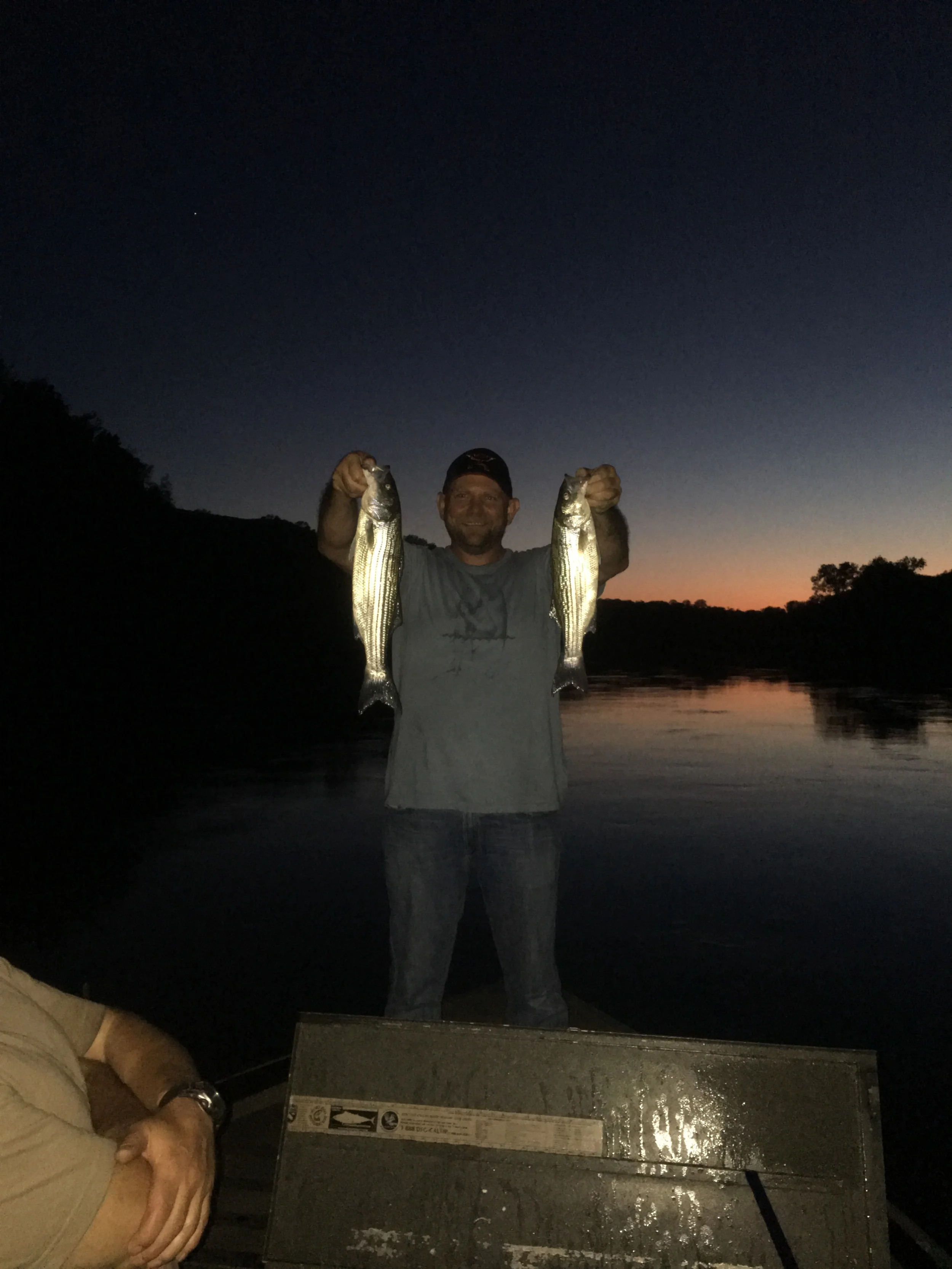 A SalmonSacRiver.com customer holds his limit of striped bass.