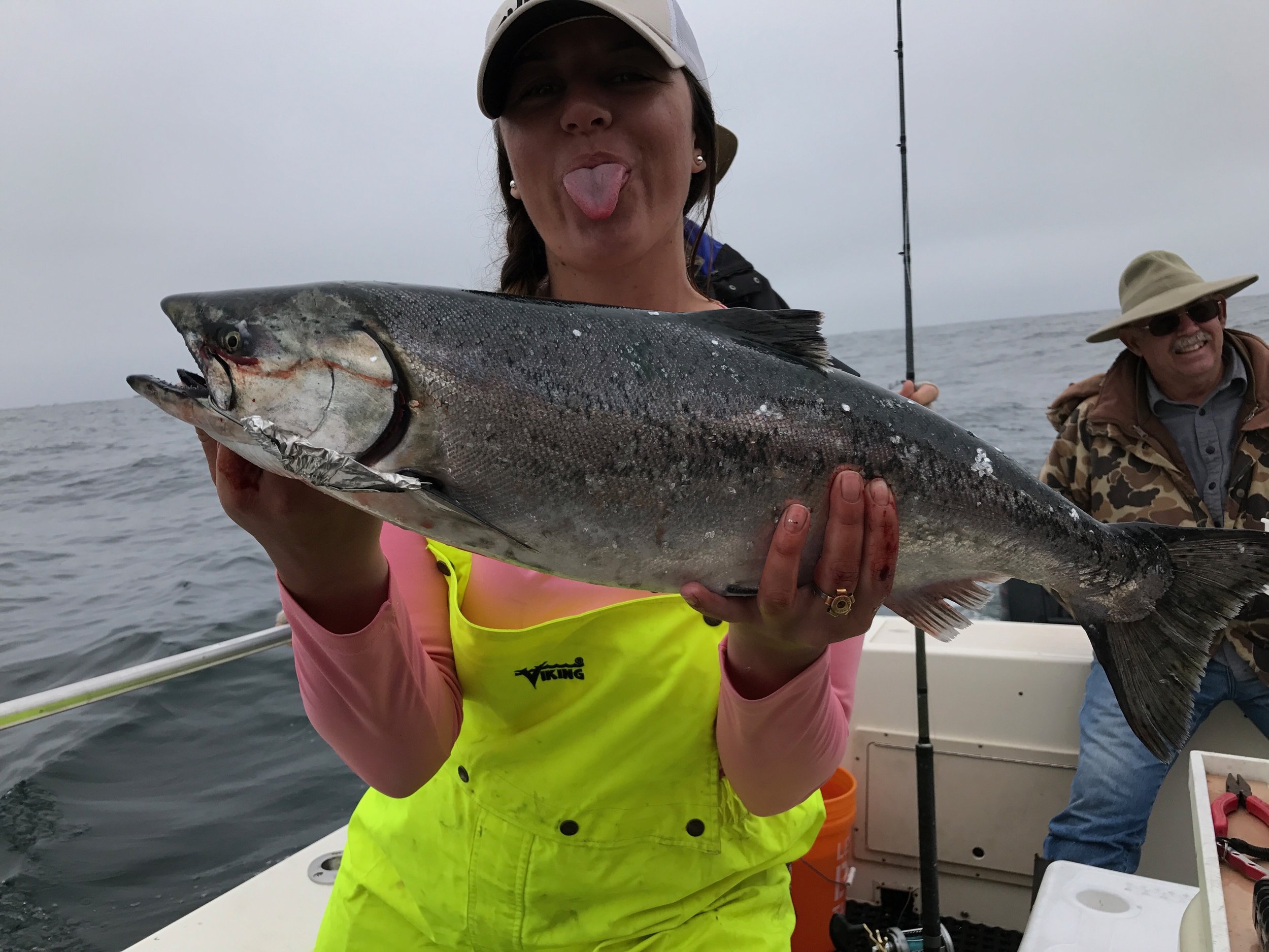The deckhand for the Legal Limit holds up a very respectable Chinook Salmon that was caught on the vessel using the" Legal Limit lunch special". This custom trolling lure was hand crafted by Mike Rasmussen of SalmonSacRiver.com in about 30 seconds, from their empty lunch containers. At the request of the captain. 