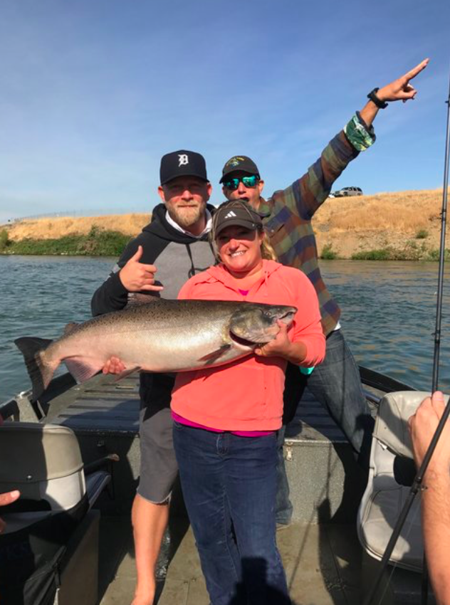 Kayla from Sherman Williams Paint Co. holds a big beautiful fall chinook salmon she caught in September, 2017 while fishing with salmon fishing guide Mike Rasmussen of Mike's Guide Service on the Feather River in Northern California.&nbsp;