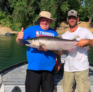 Fishing Guide John Pearl Holding A King Salmon