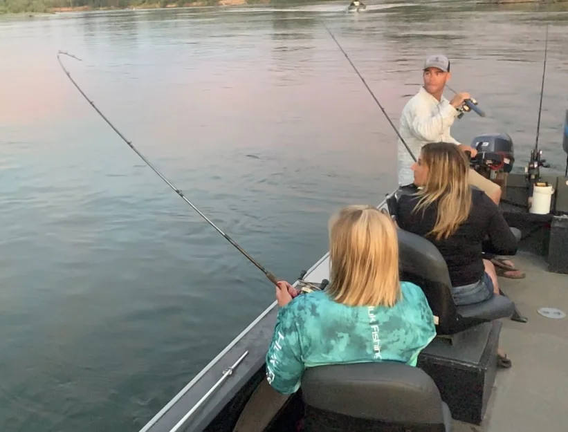 Salmon fishing guide John Pearl watches on as one of his guest hooks up on a dime bright King Salmon opening morning. The group was fishing on the Sacramento River near Los Molinos, Ca.