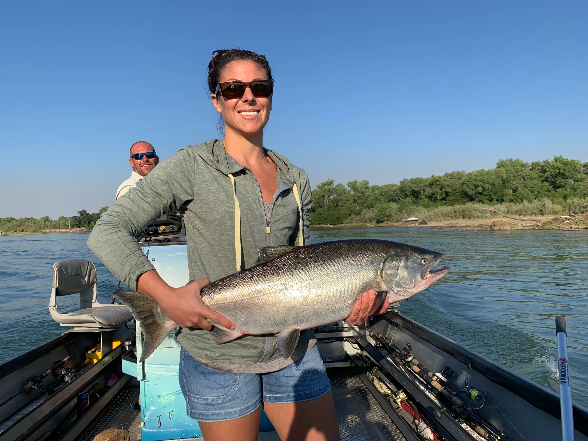 Salmon fishing guide Mike Rasmussen worked the daily fishing charter on July 27, 2019 for a young couple that booked a daily salmon fishing trip on the Sacramento River near Los Molinos, Ca. The first ever salmon for this gal came while back trollin…