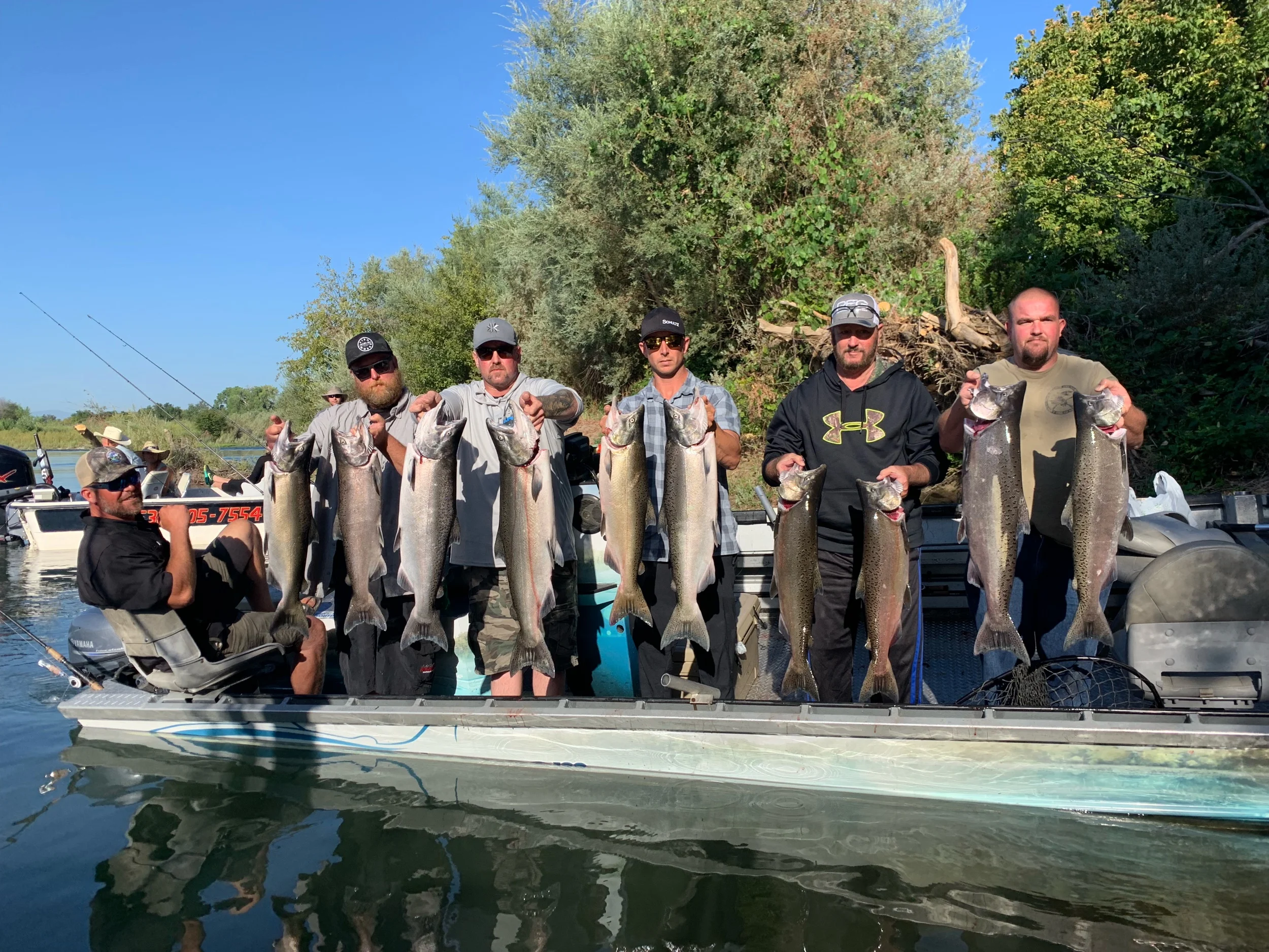 Fishing Guide Ryan Tripp took this photo of his salmon fishing crew and fellow guide Mike Rasmussen. At just after 8:00am on opening morning at the Barge Hole. The group of anglers found fast action and easy limits while fishing “plugs” (salmon lures) at the Barge Hole on August 1, 2019.