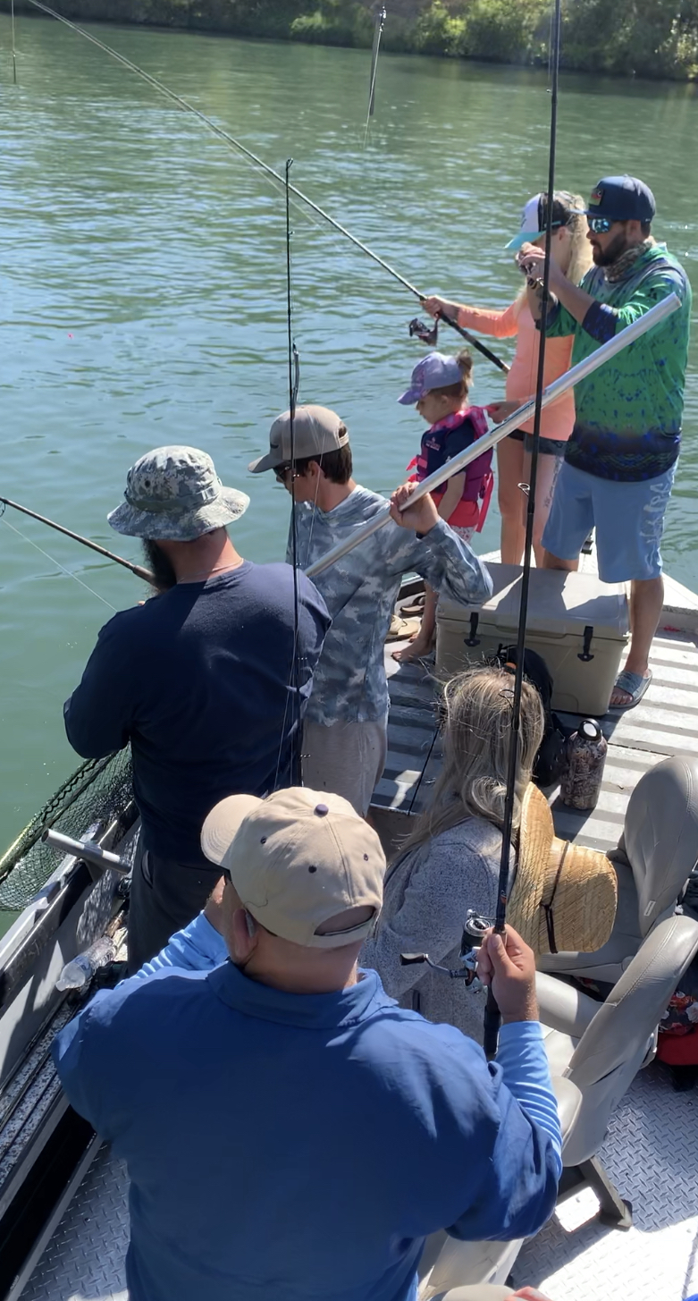 Salmon fishing guide Ryan Tripp is photographed directing traffic up in the mix of the “fish on” chaos. Joe Cimino and guests, as well as Greg Collier and guest. Watch on as the battle with a king salmon pursues. This salmon was caught dragging roe near Red Bluff, Ca on August 22, 2019.