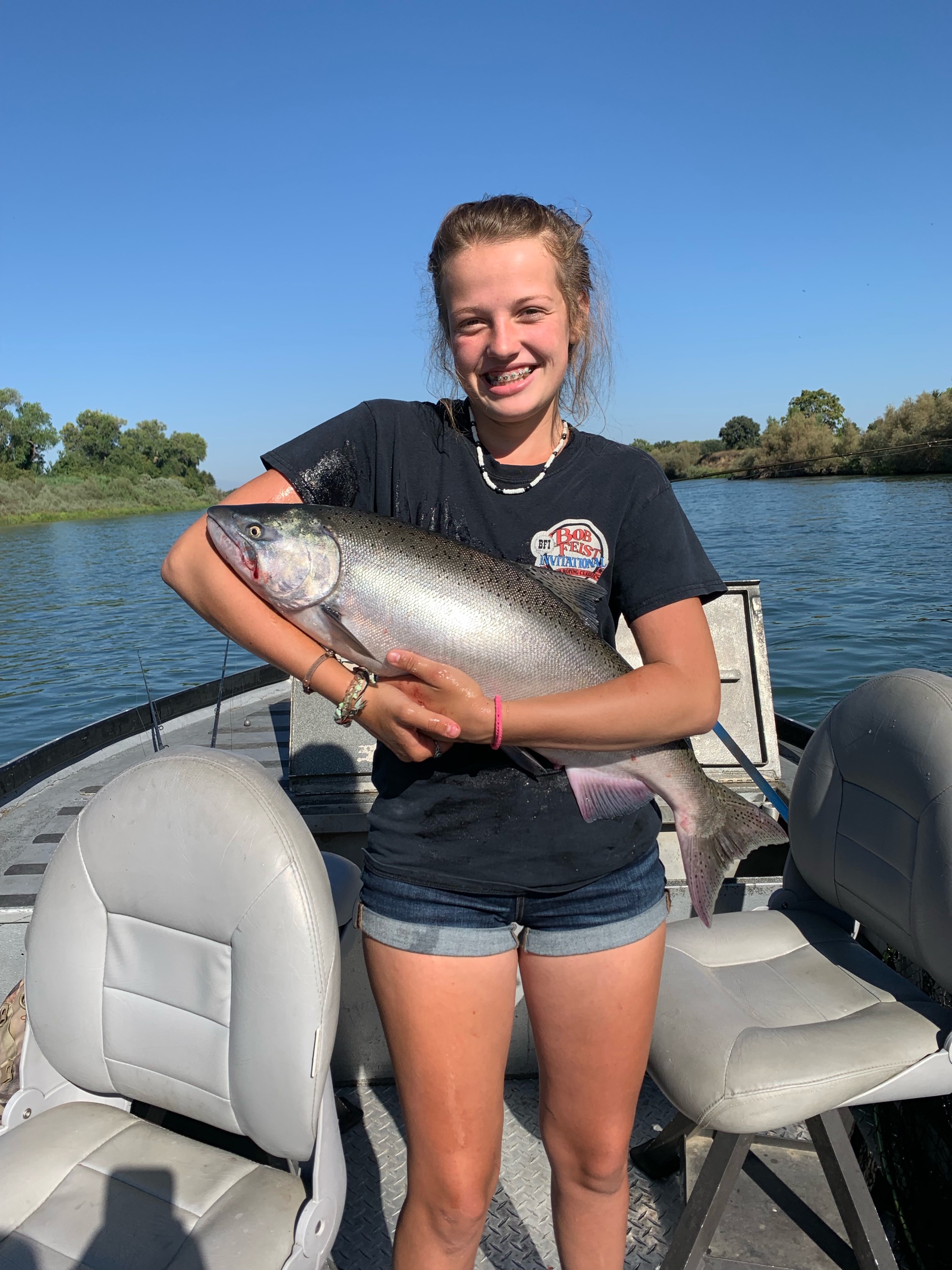 Riley Gradney from Dairyville, Ca does her famous cradle pose holding a dime bright king salmon she caught while back bouncing cured salmon roe on August 24, 2019.