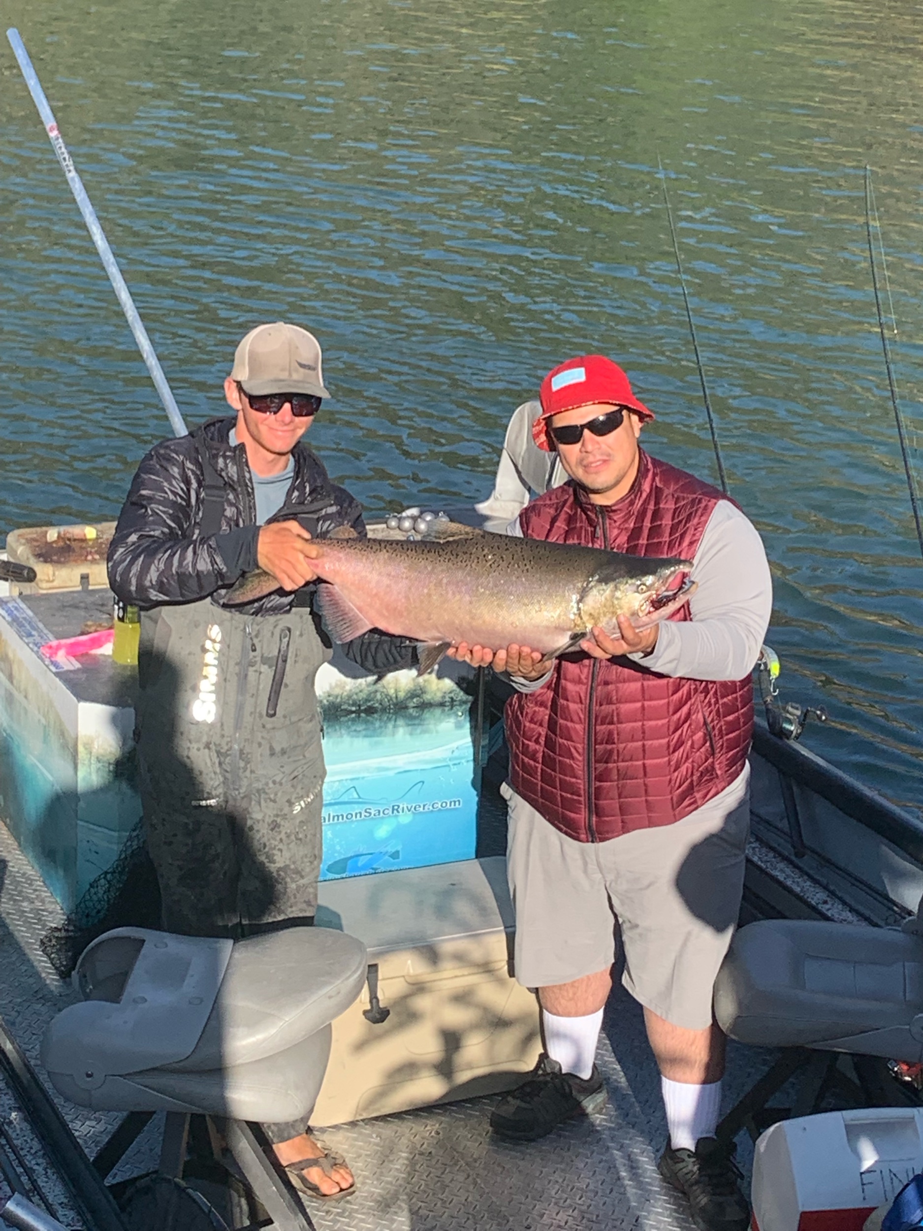 Salmon fishing guide Ryan Tripp poses with a client holding a large buck chinook salmon. This thick buck was caught using a silent 4.5 Maglip in the solid chrome pattern. September 6, 2019.