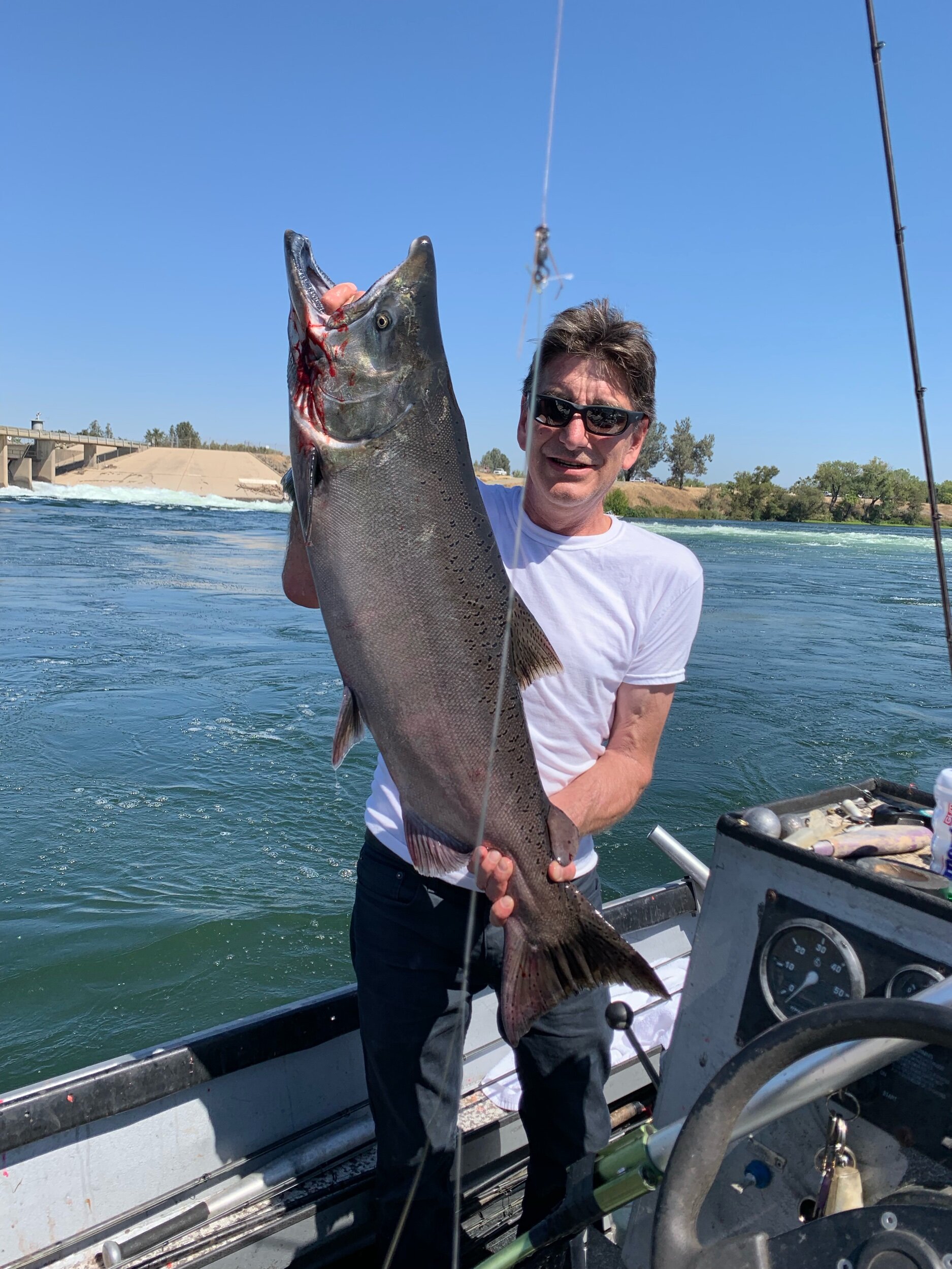John Kirk from Southern California holds up one of his catches from his groups two day salmon fishing trip on the Feather River in Northern California.