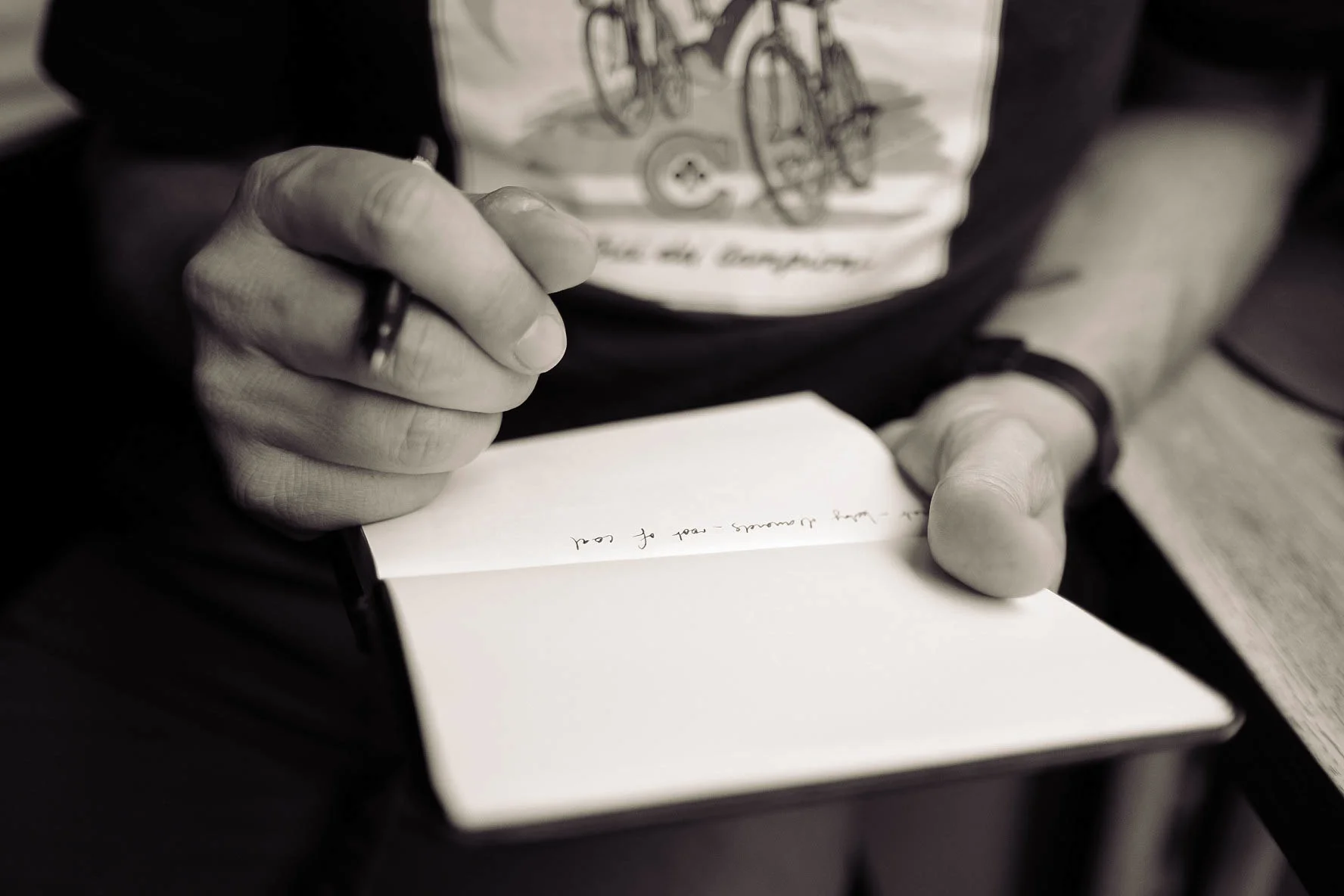 Person writing on notepad