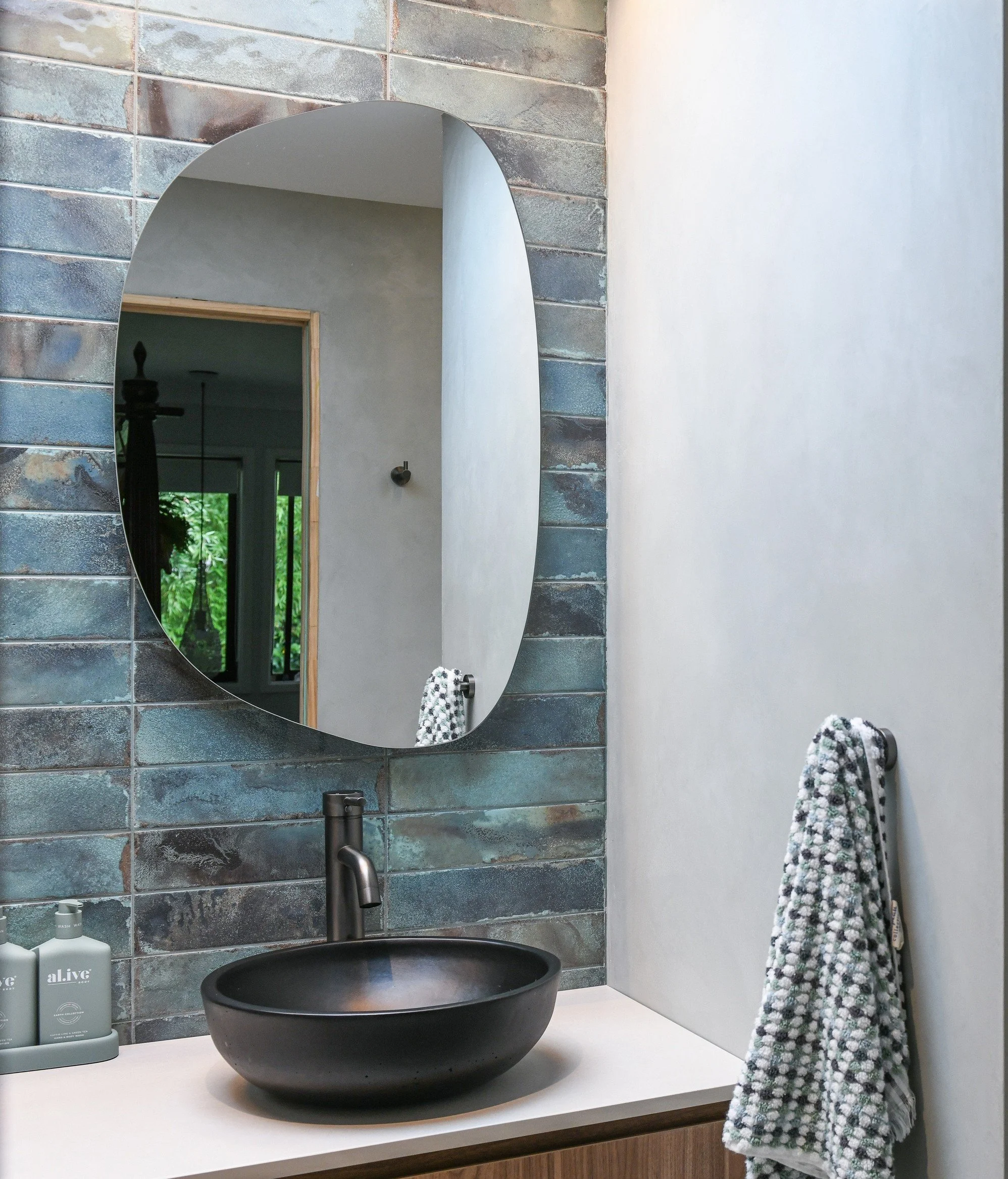 Bathroom Vanity with teal distressed tile splashback. 