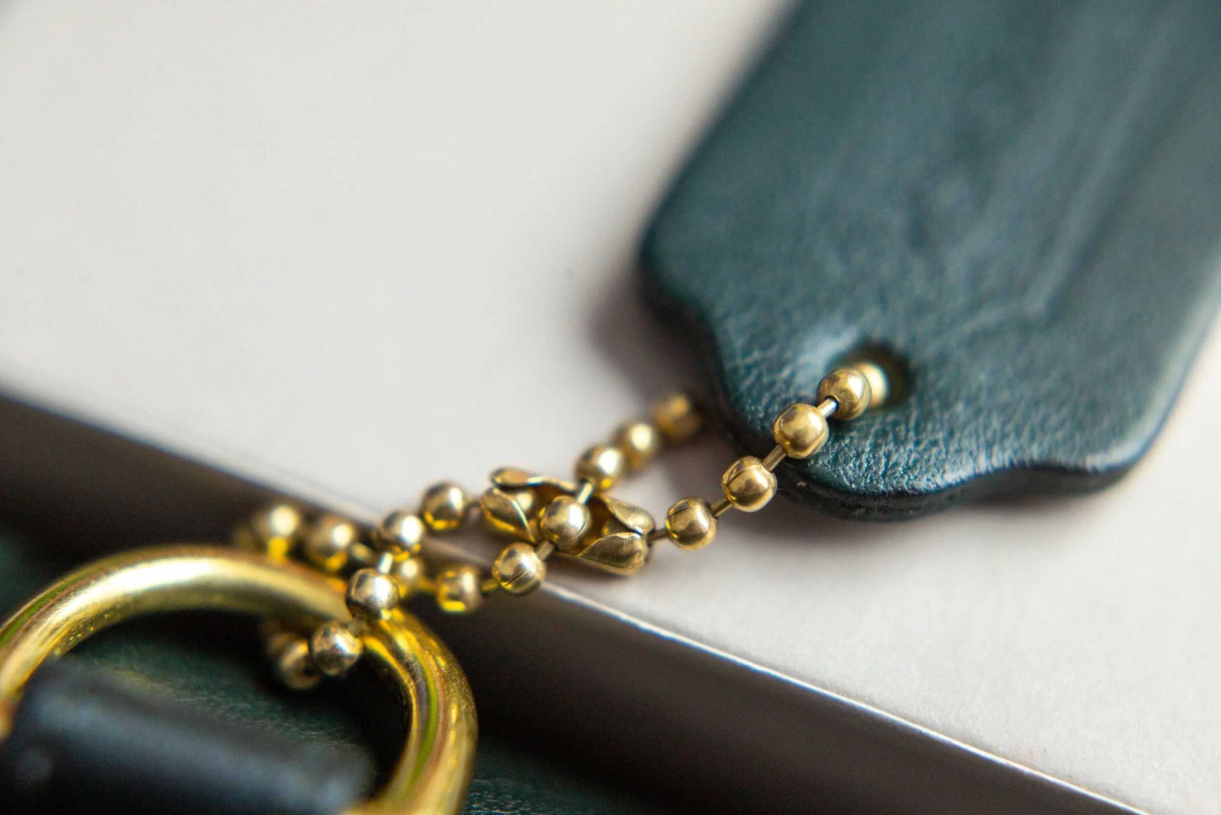 Embossed logo is fading away. Brass hardware has not tarnished