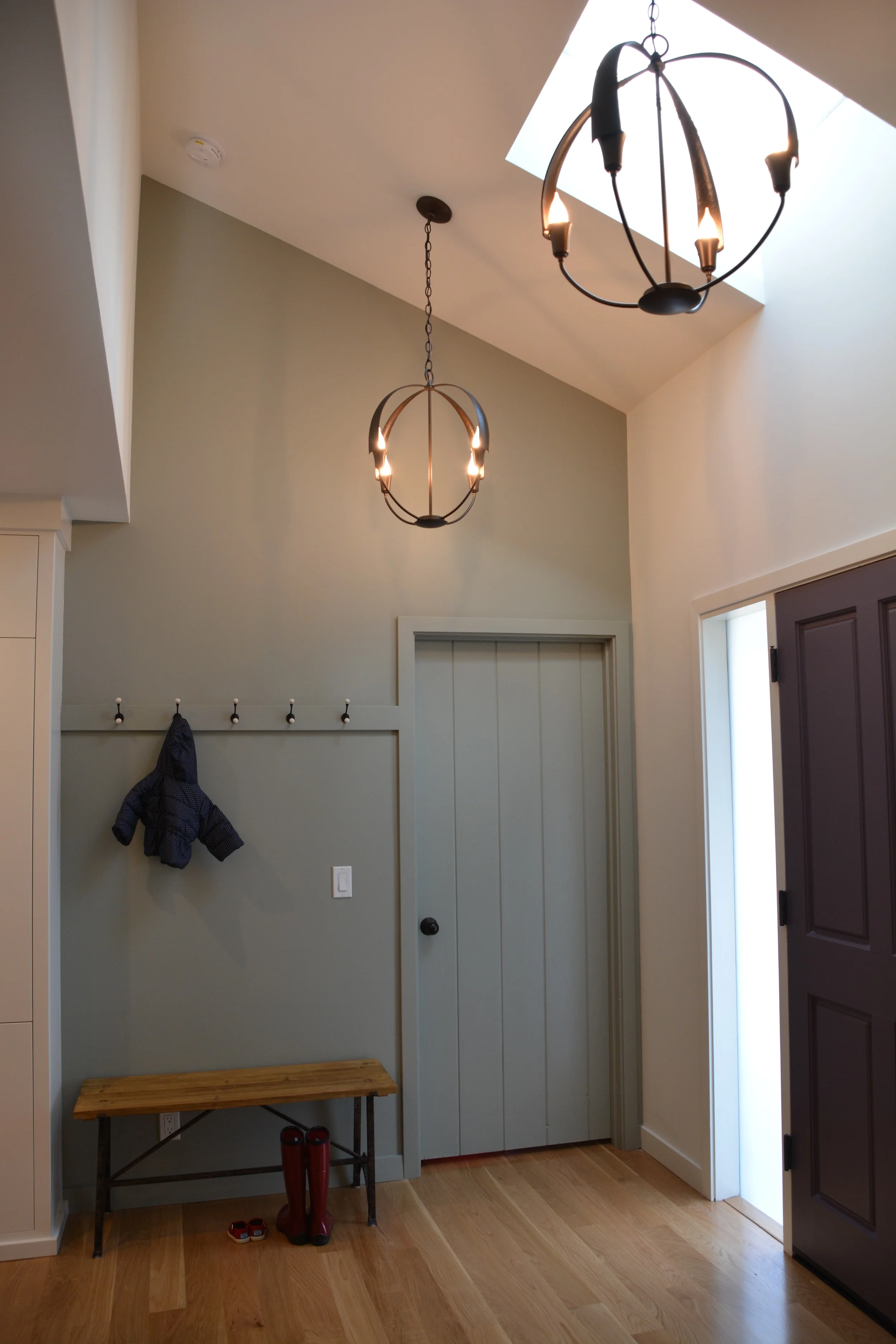  We added new lighting, hooks, color and an inviting bench to create a freshened-up entry. 