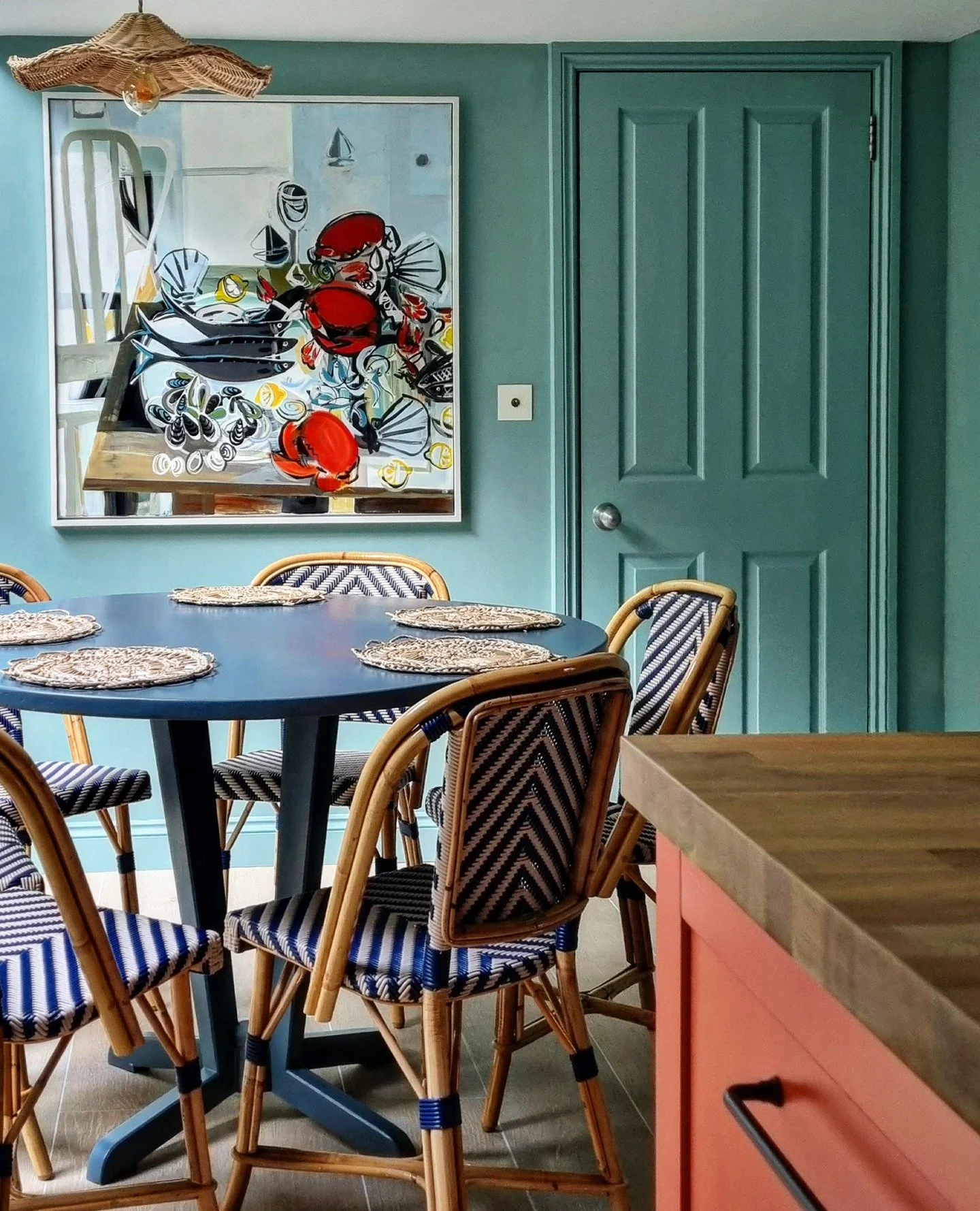 Fowey Cottage : The dining area next to the kitchen is dominated by this fabulous painting by @marissa__weatherhead - colourful, energetic and full of summer holiday vibes.

We swapped the heavy wooden rectangular dining table here for a smaller circ