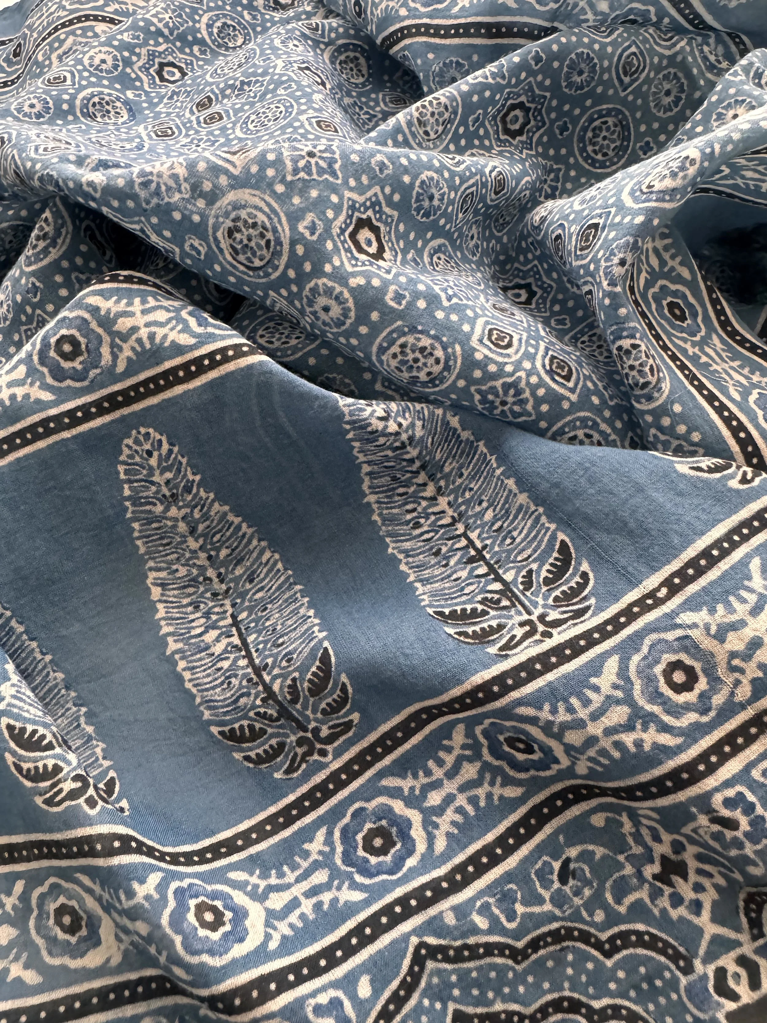 Handblock printed Ajrakh pattern detail on soft mulmul cotton, showing natural indigo dye and iron black outlines