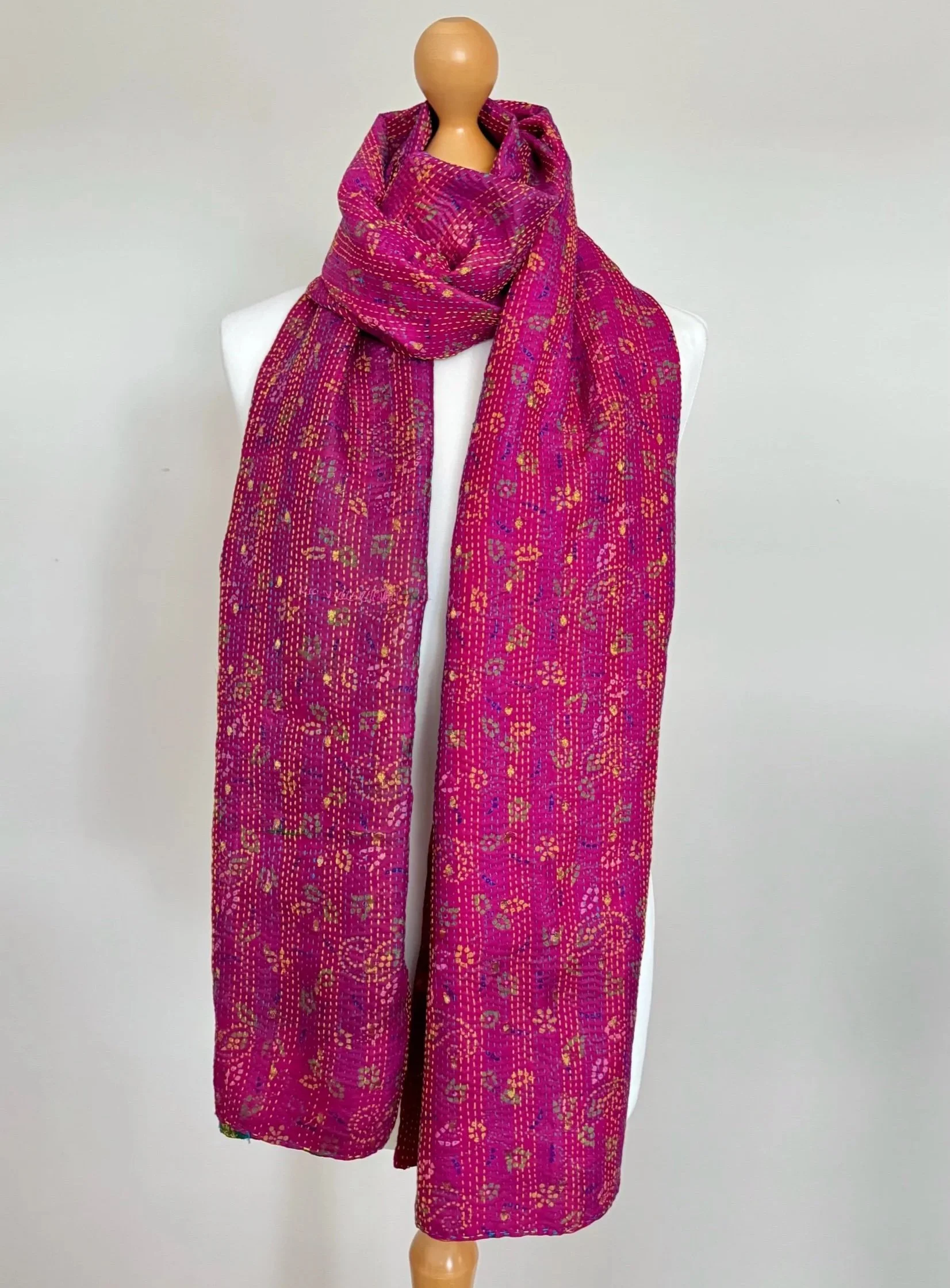 A colourful pink floral handmade scarf crafted from upcycled sari silk and hand embroidered with Kantha stitch